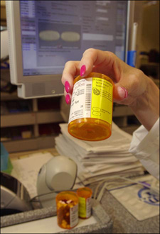 Human pharmacist double-checking the robot's