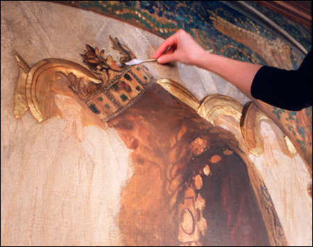 mural being cleaned with giant cotton