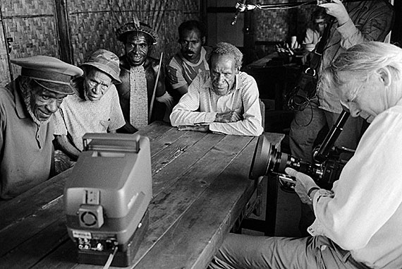 In a still from “Dead Birds Re-encountered” (2013), Weyak (far left), the Dani warrior profiled in “Dead Birds,” watched the film 28 years later with Gardner (far right). 