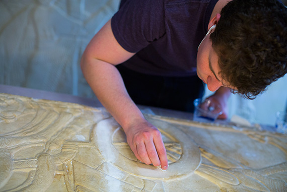 Noah Wuerfel ’17 gently repairs a plaster cast of an ancient relief.