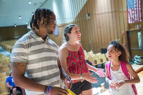 Javion Rookard (from left), CYEP director, and Sarah Gonzalez '18 work with Amaya Fifield, an Amigo School eighth-grader.