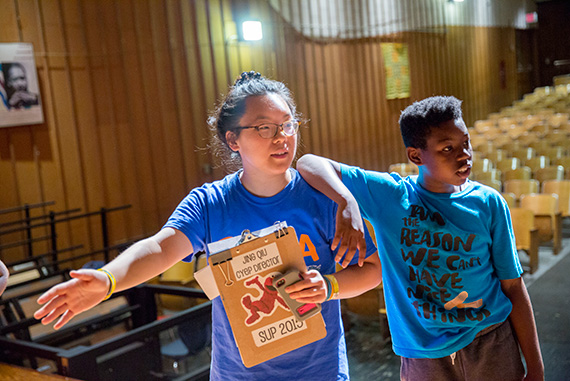Jing Qui '16 works with Joshua Aldinor, a sixth-grader from Benjamin Banneker Charter Public School.