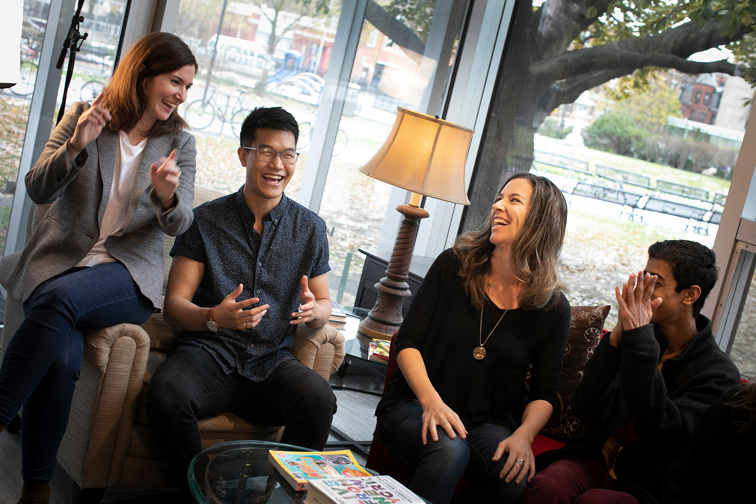 In 'Laughing Room' installation, people sit on couches, laughing.