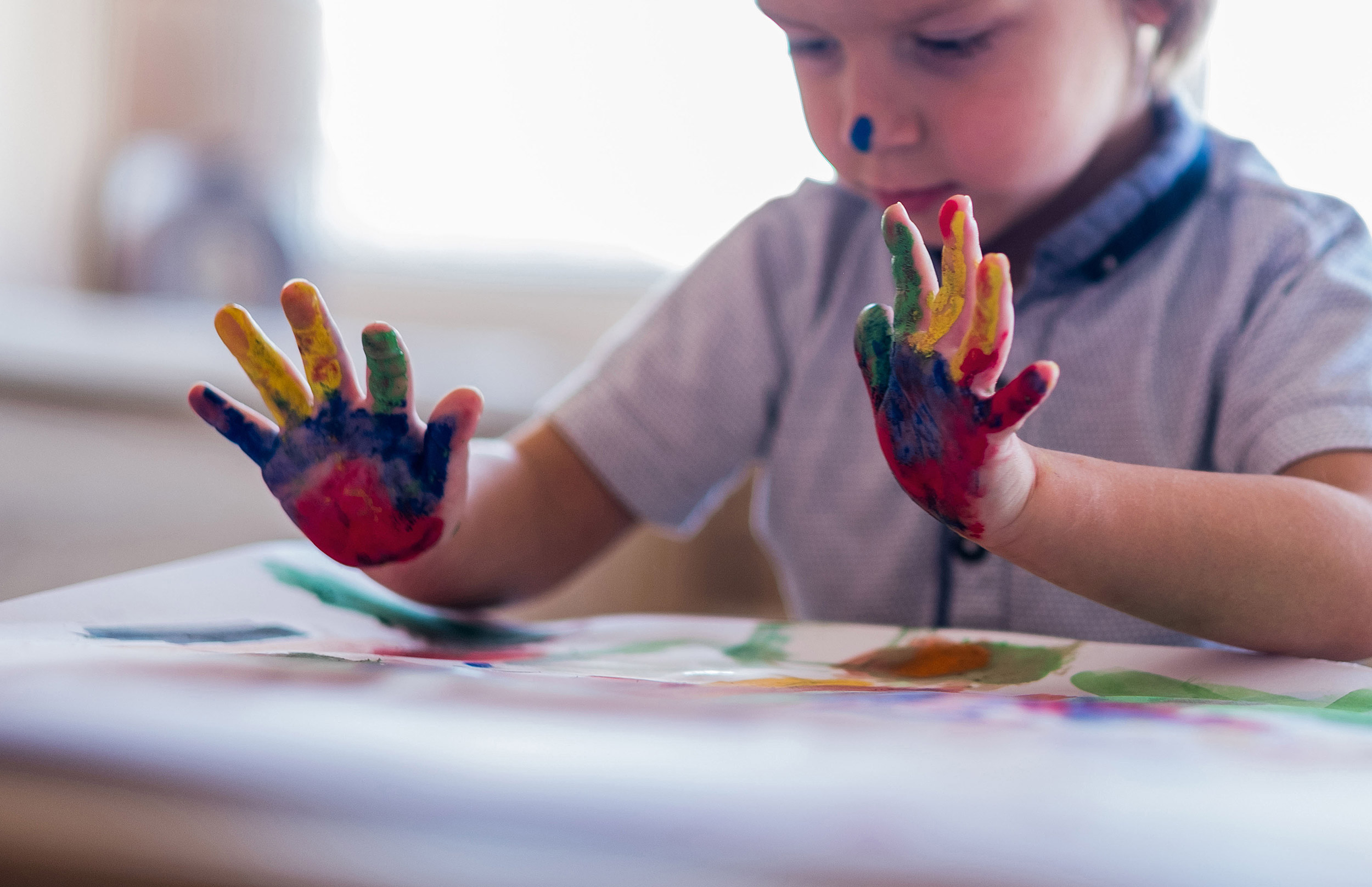 Little boy is doing handprint