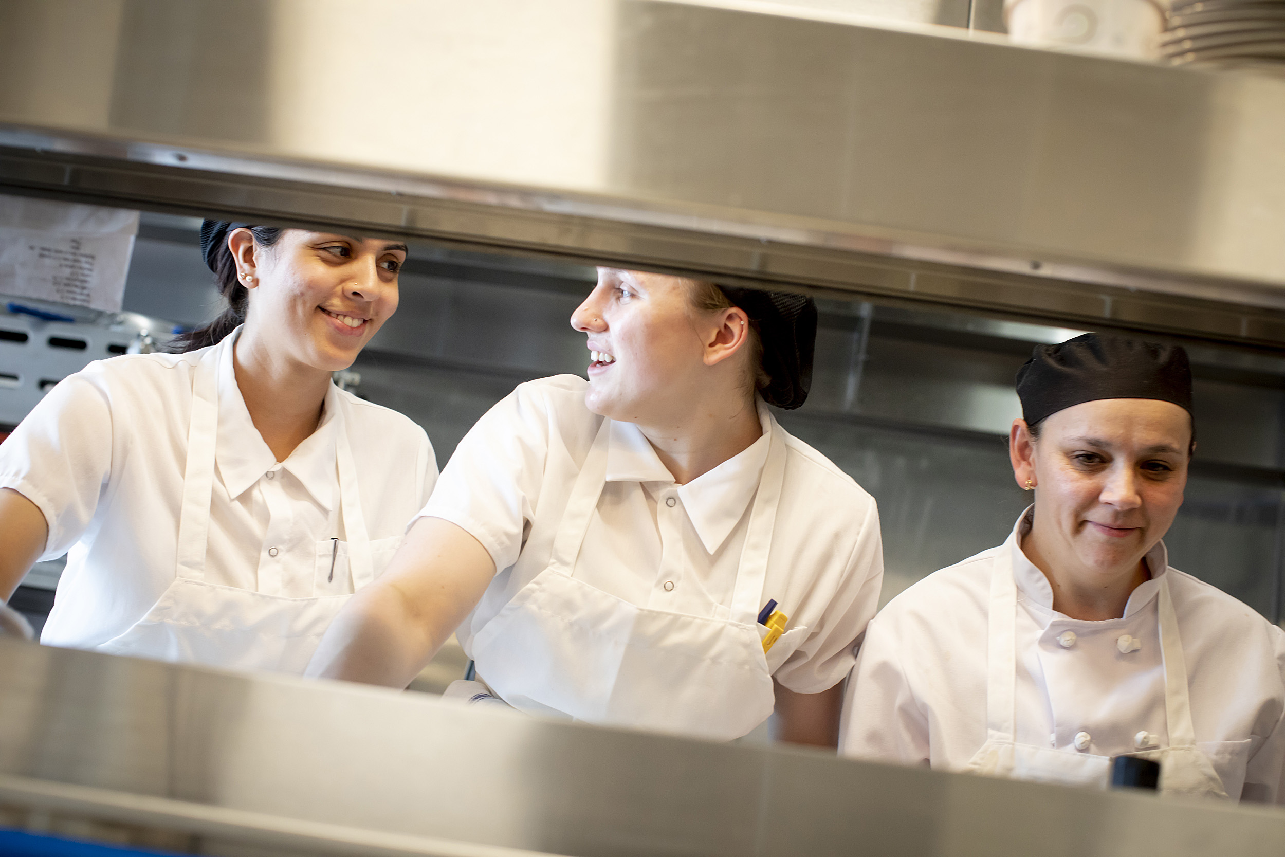 Chefs, Vanessa Portiza Acosta, from left, Corrine Gaucherin and Luz Restrepo Rincon work on the line in the kitchen at The Heights