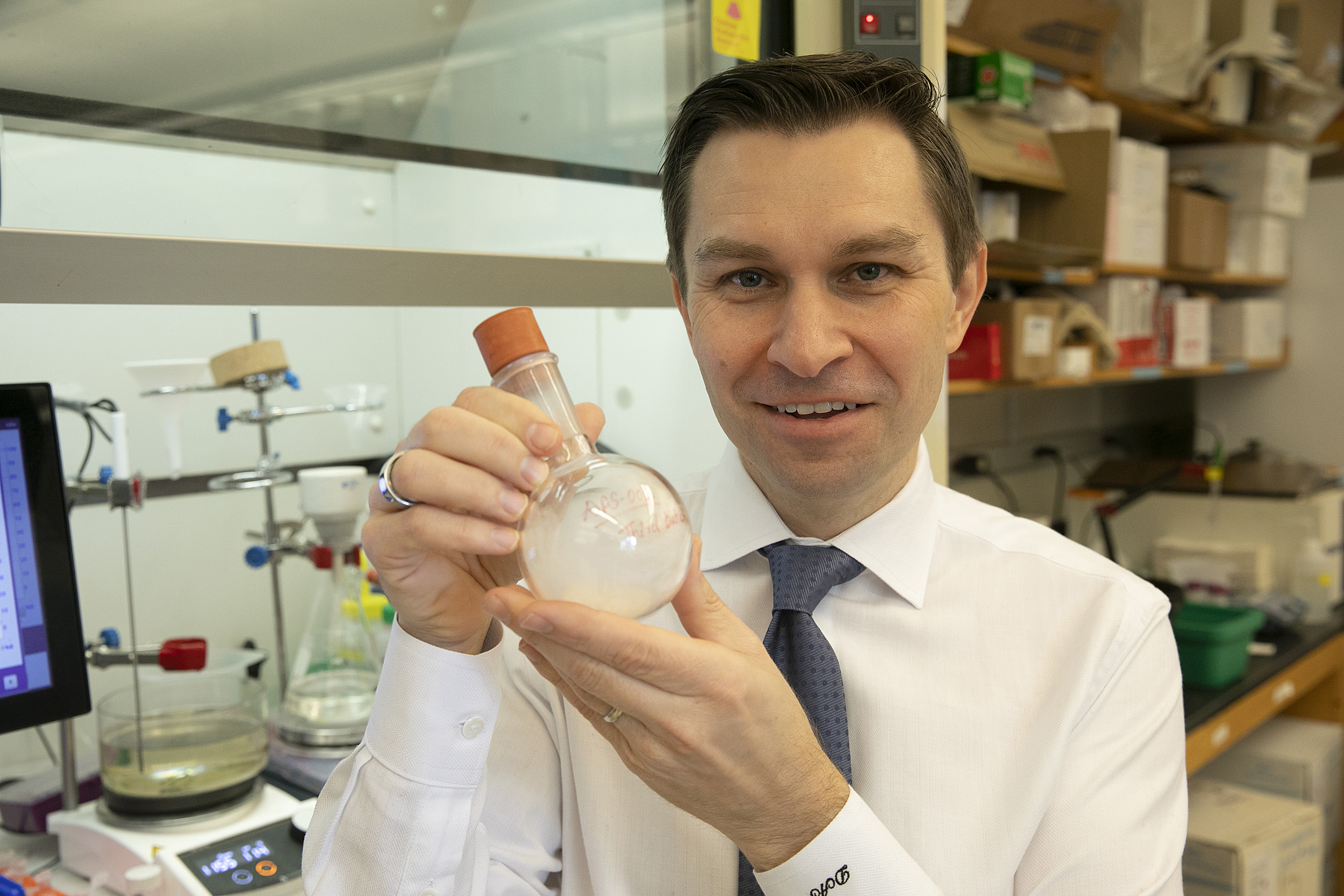 David Sinclair shows off an evaporator device used in the lab.