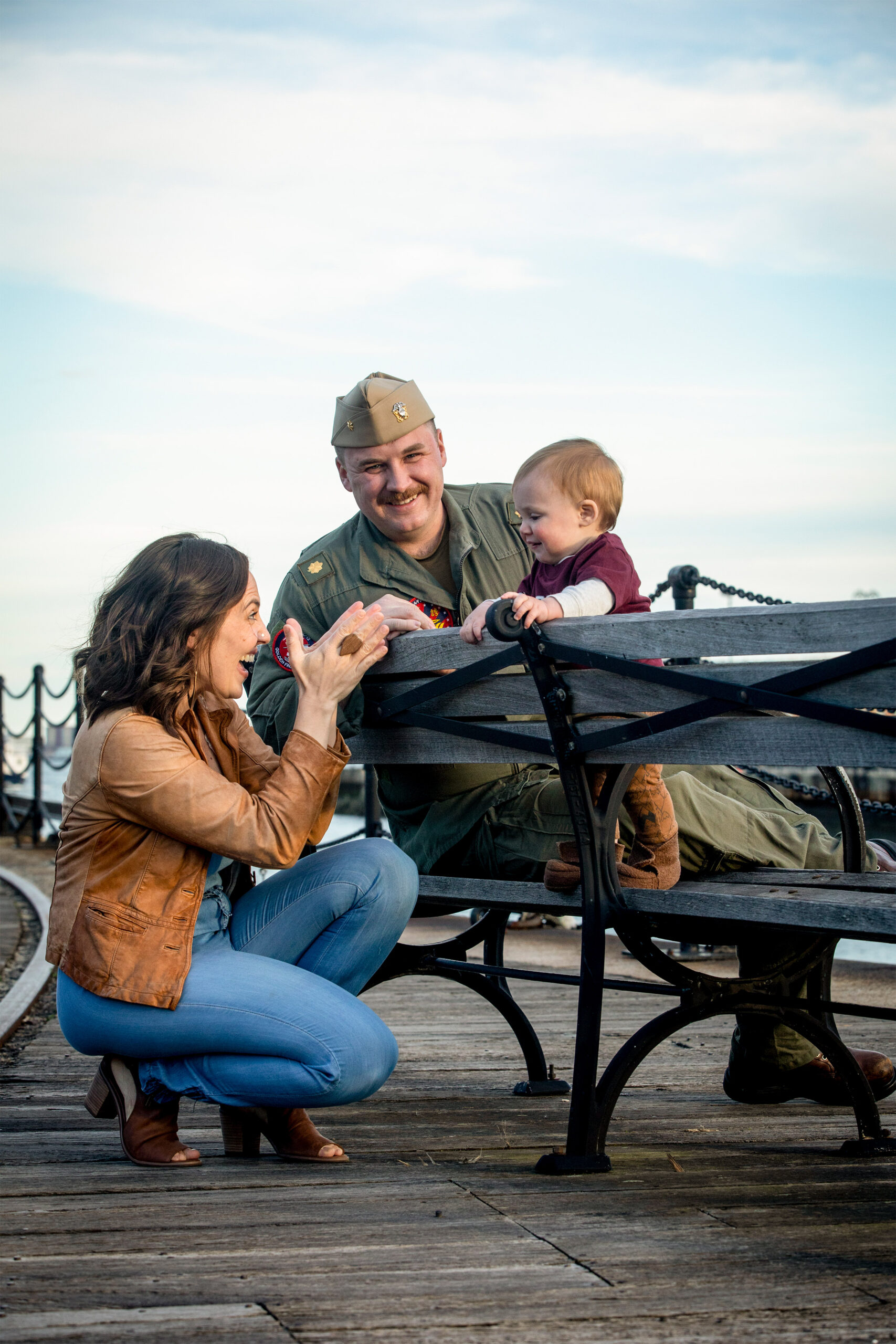 Moore, his wife, and their child on a bench