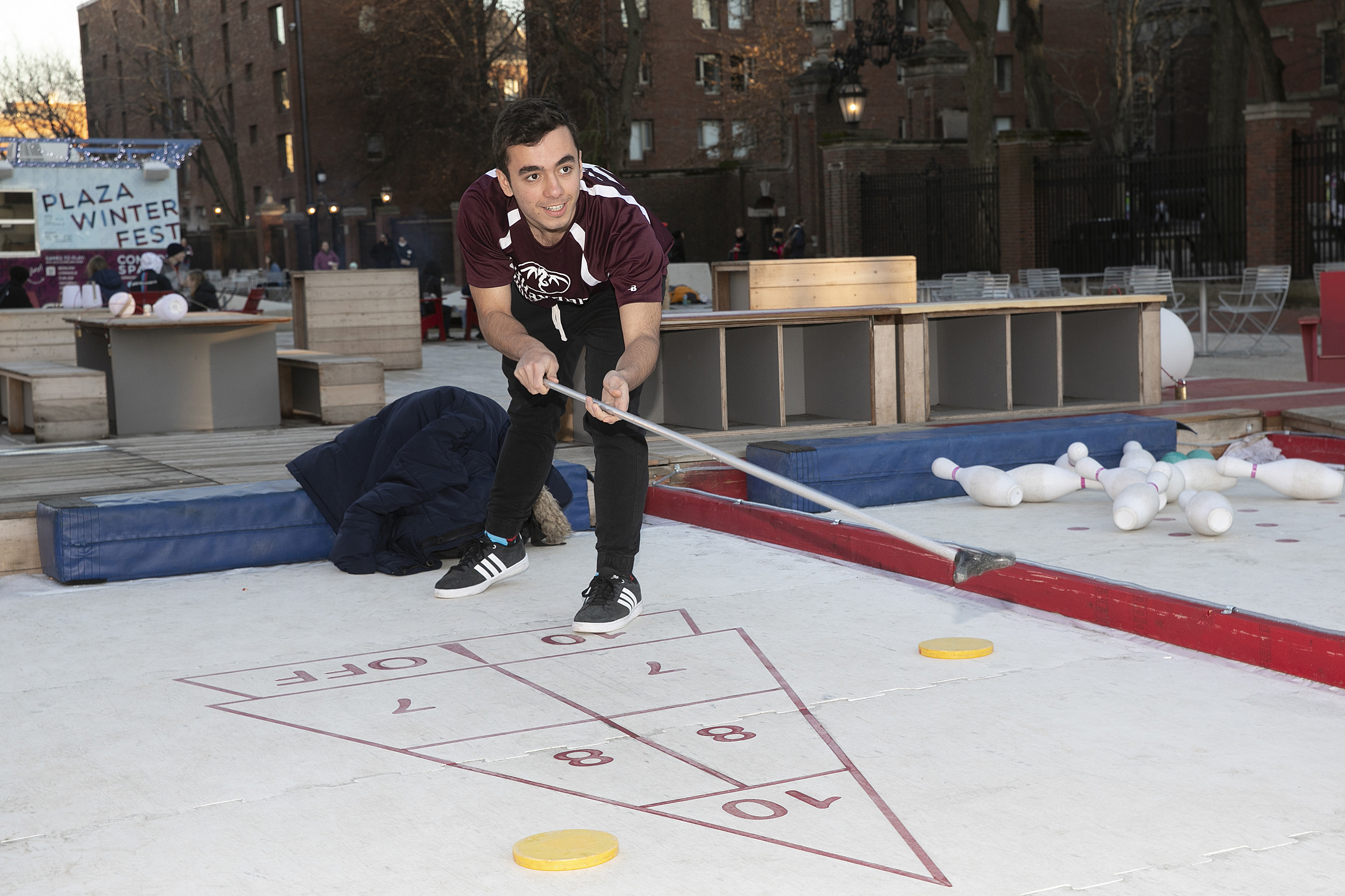 A student playing shuffle board outside