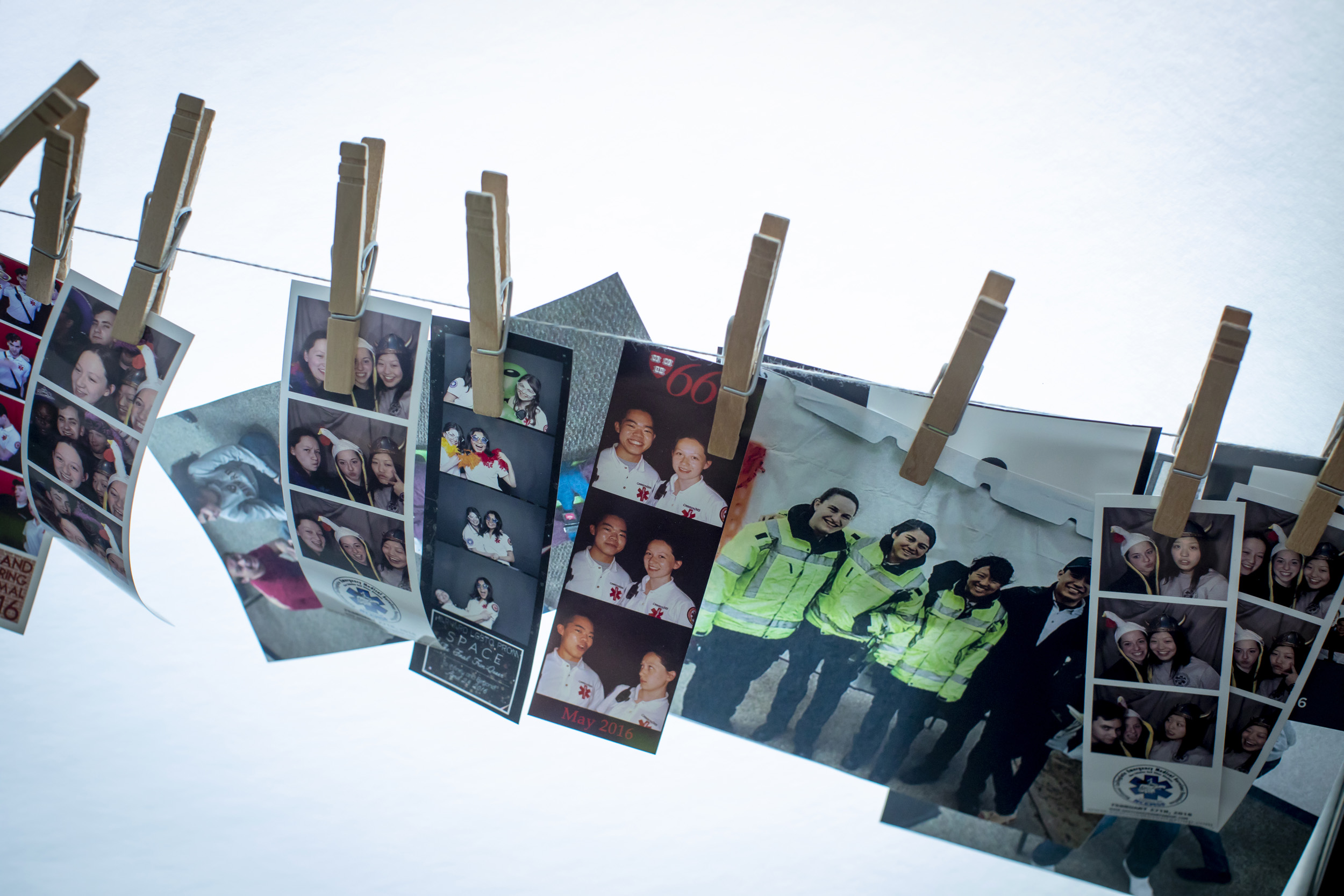 Photos of student EMTs and instructors are clipped to a line at Crimson EMS.