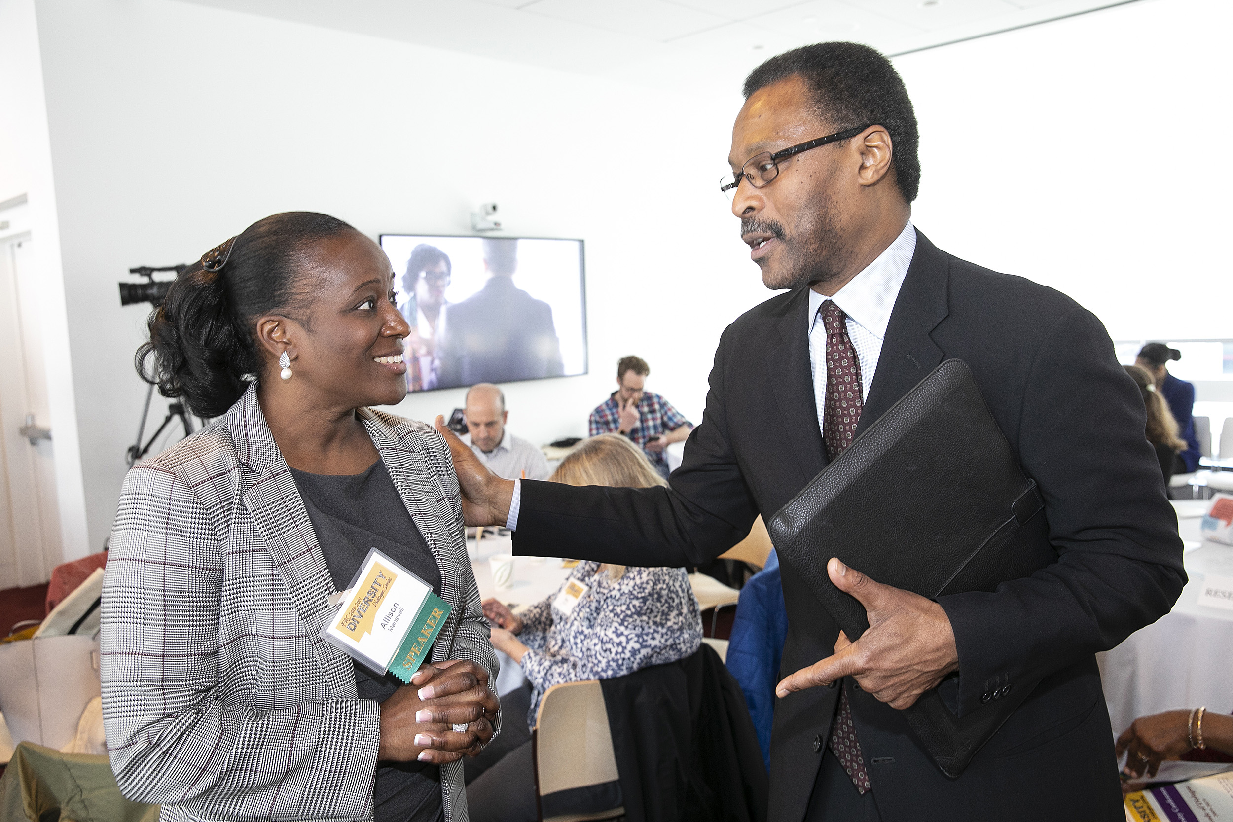 John S. Wilson Jr., senior adviser to the president, speaks with panelist Allison Manswell.