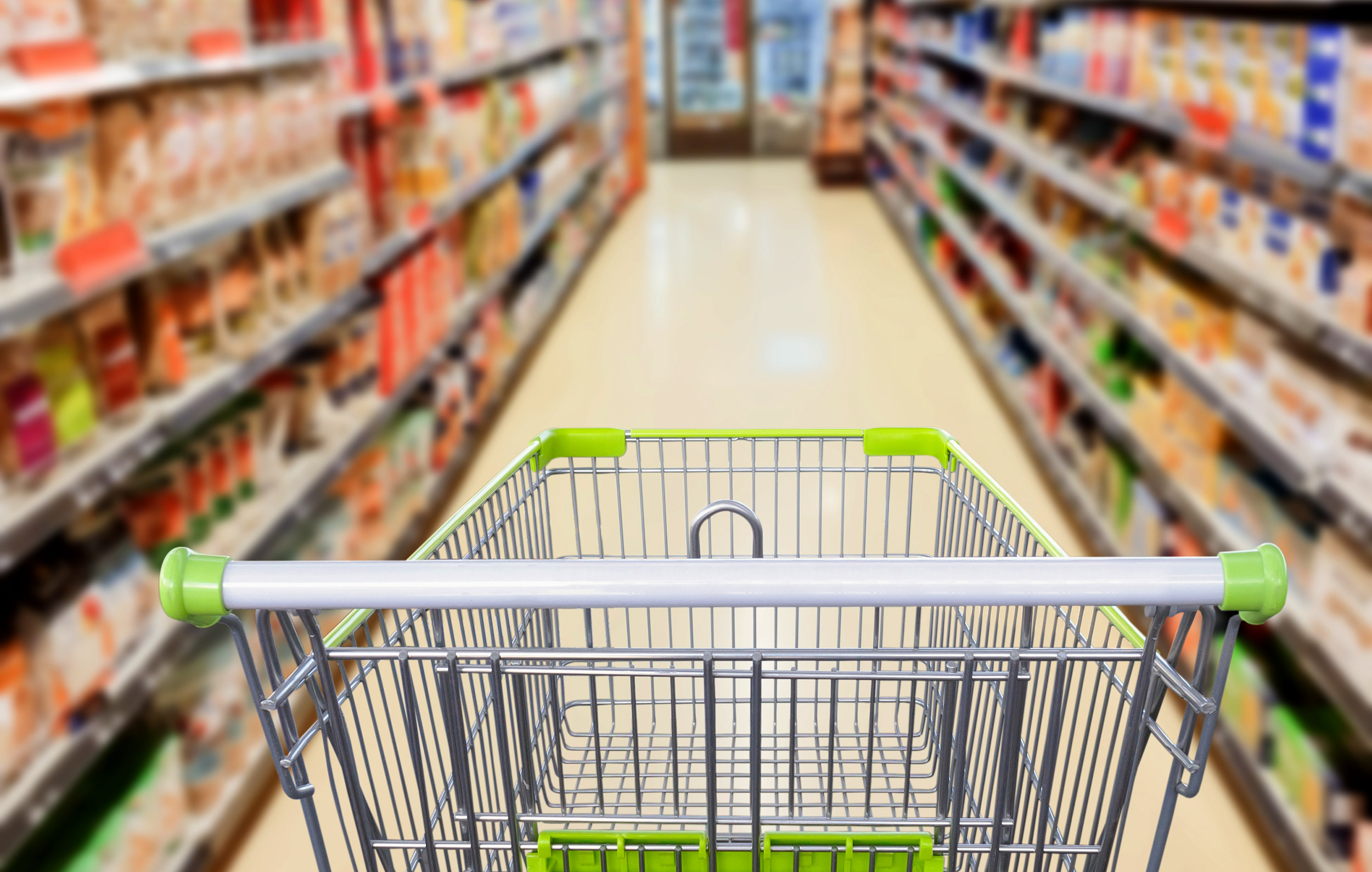 Supermarket aisle with empty shopping cart