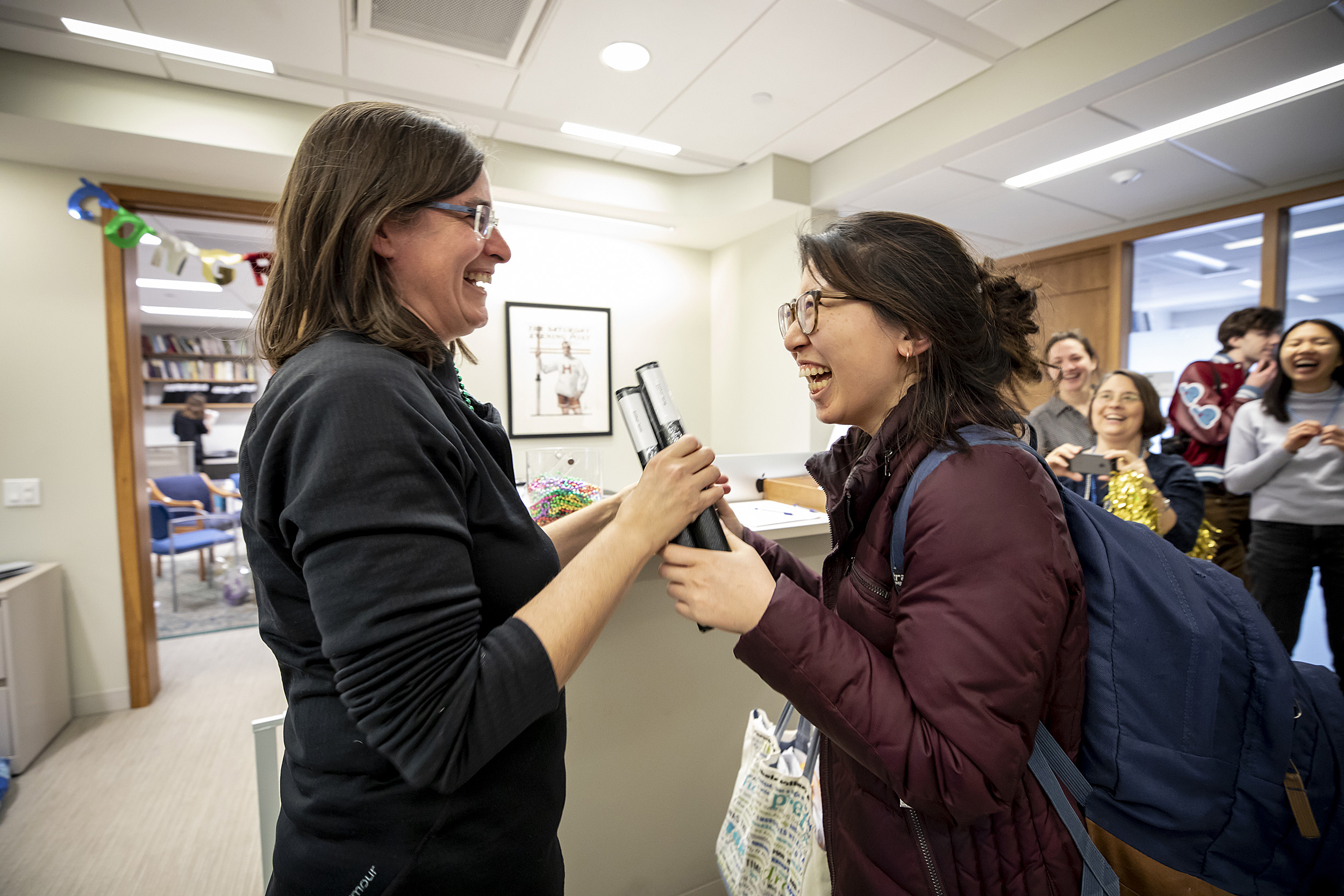 Hyo-Won Jeon, on right, senior concentrator in Social Studies handed in her thesis on "Thesis Day" to Nicole Dejong Newendorp,