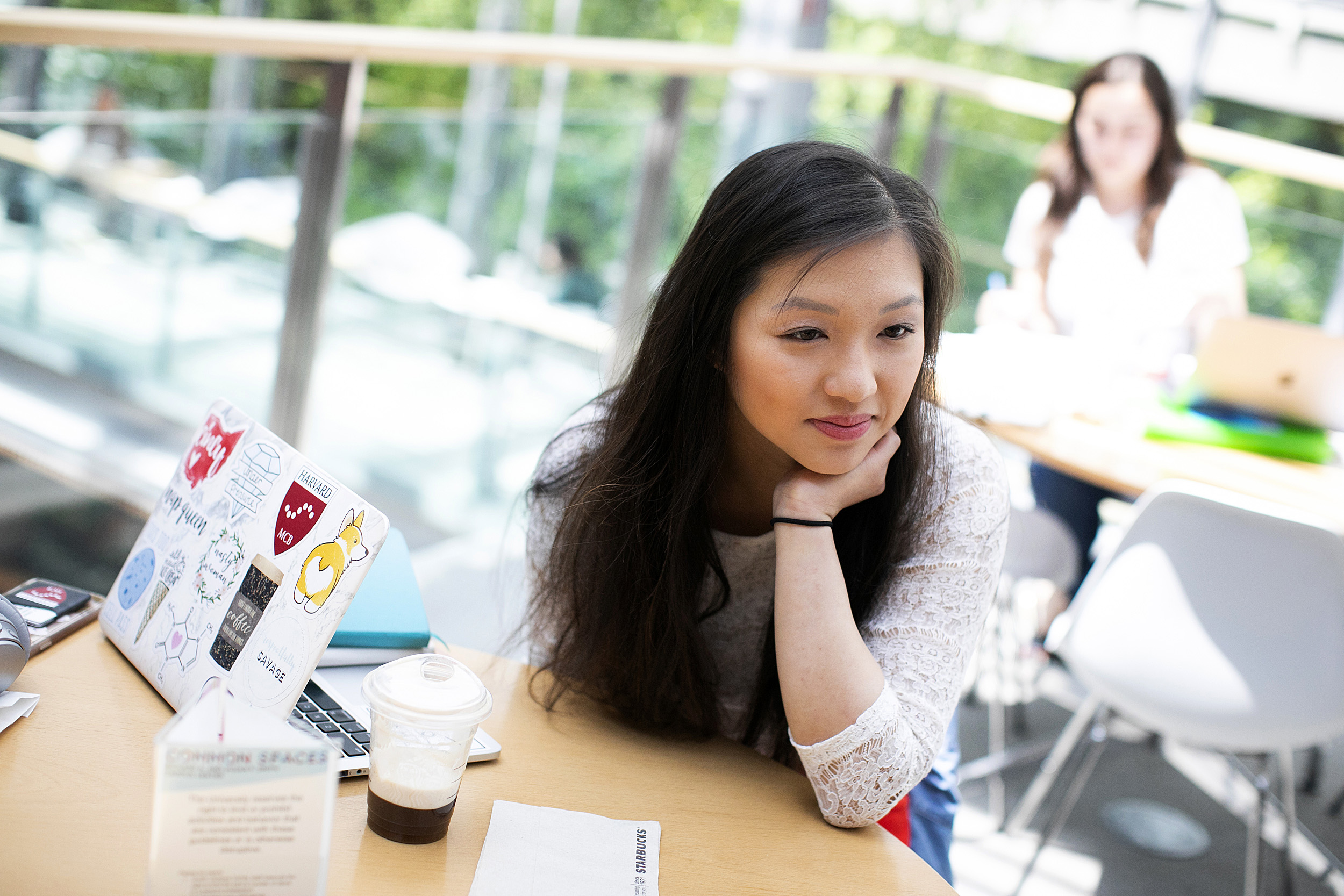 Allison Yan looks pensive next to her sticker-covered laptop