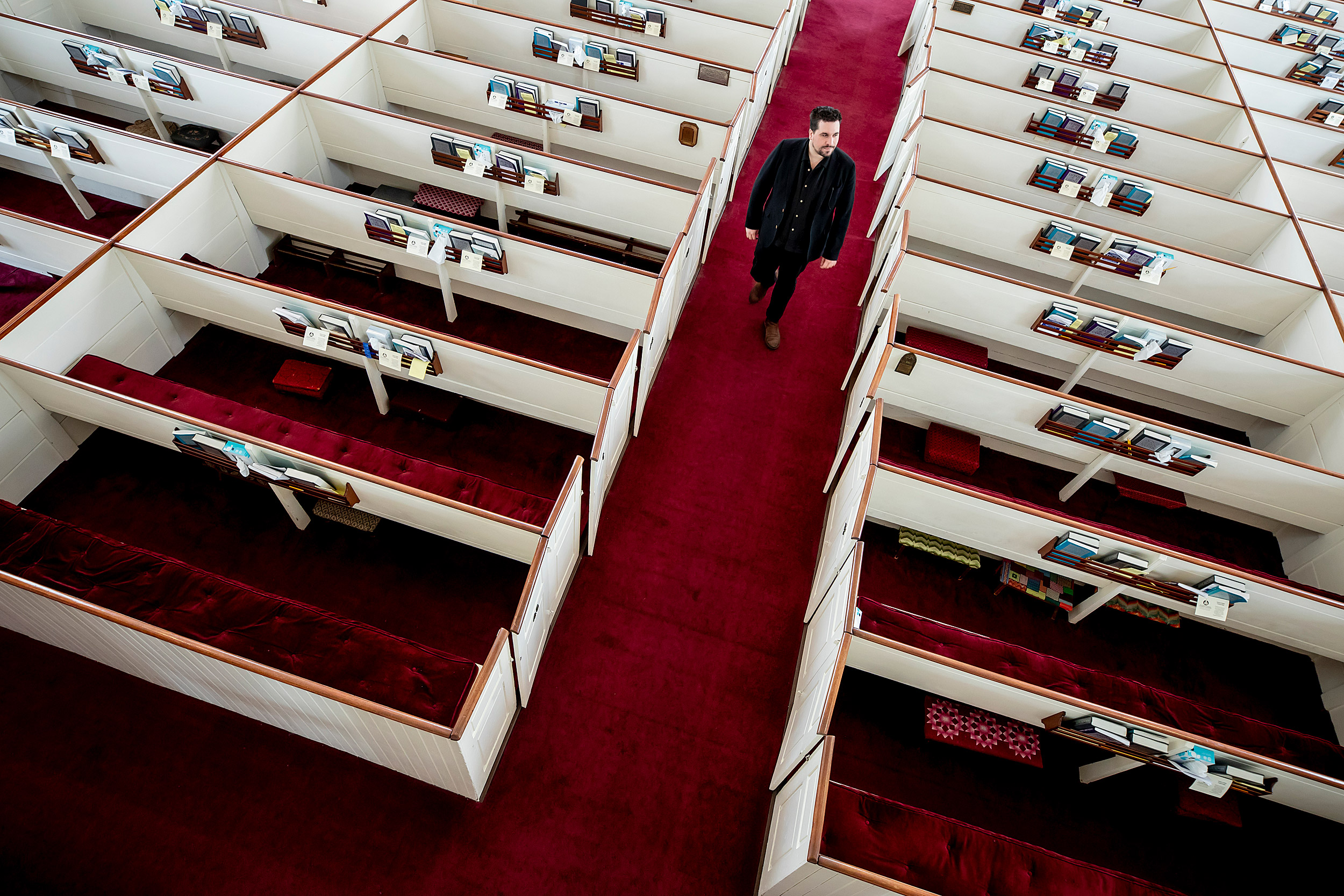 Israel Buffardi walks down the aisle of the church where in interns.