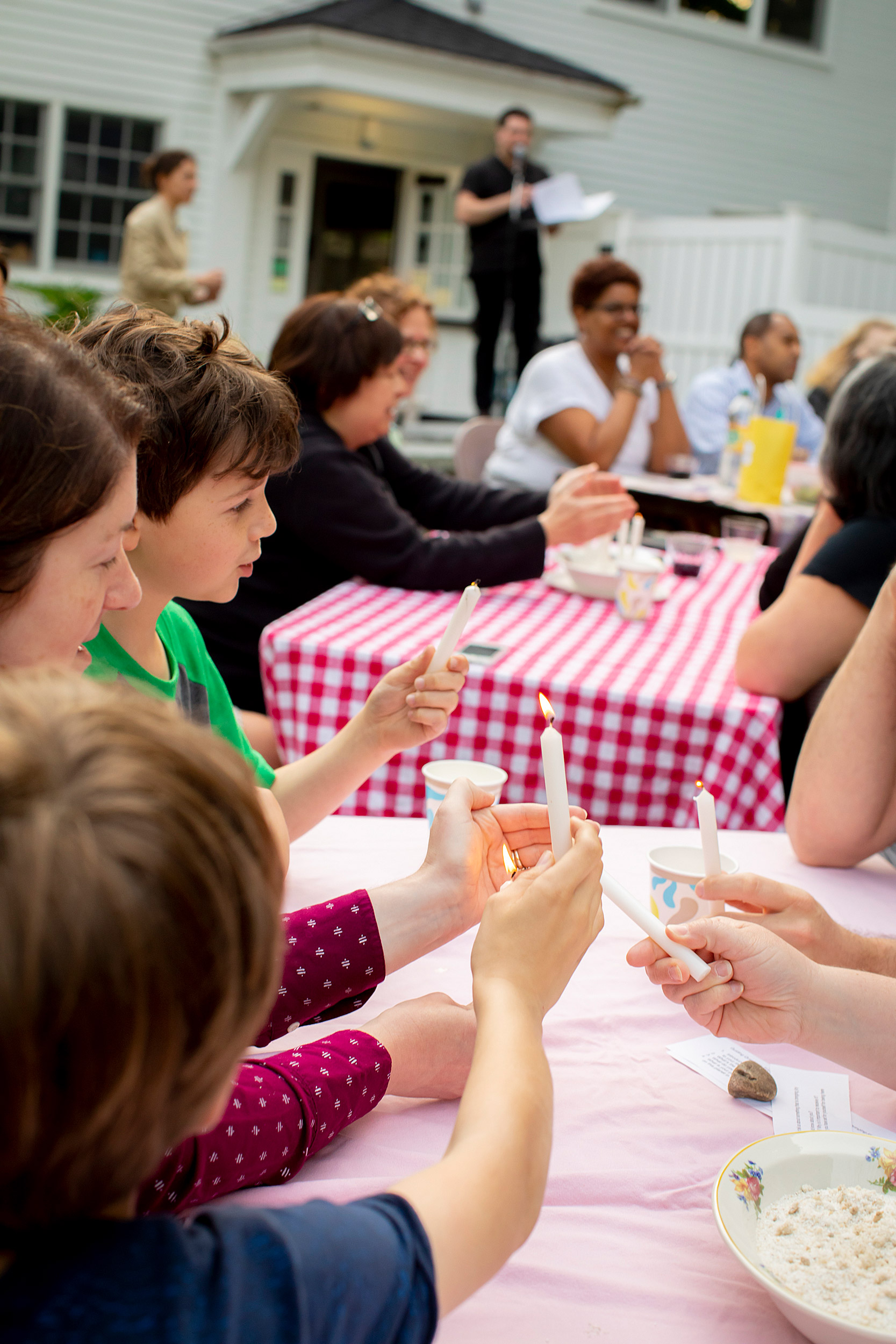 Congregants eat, light candles at a Sacred Supper.