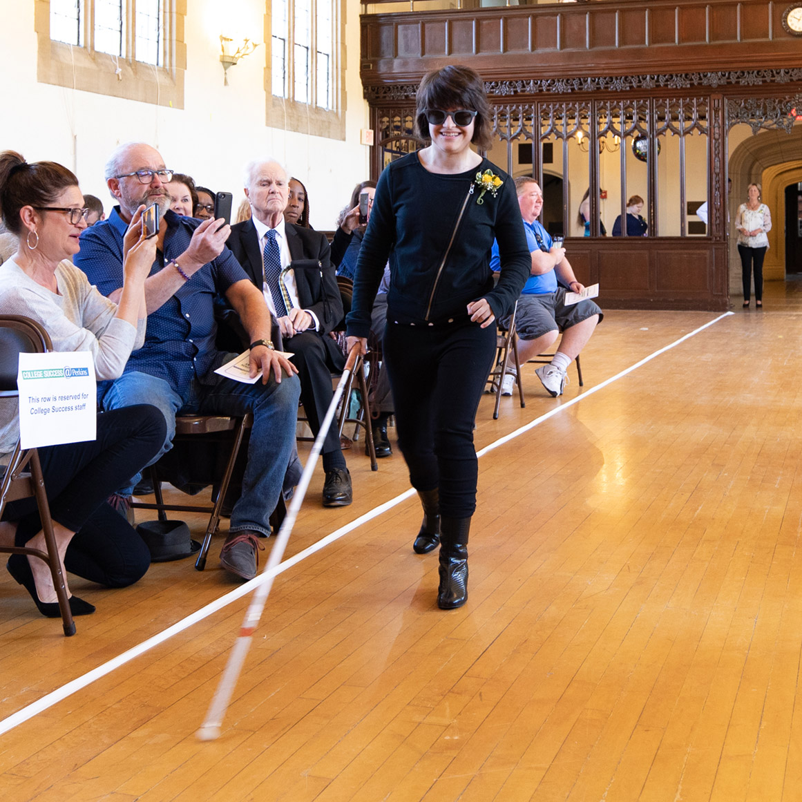 Jordan Scheffer approaches the stage in Perkins’ Dwight Hall at the May 2019 College Success graduation ceremony.