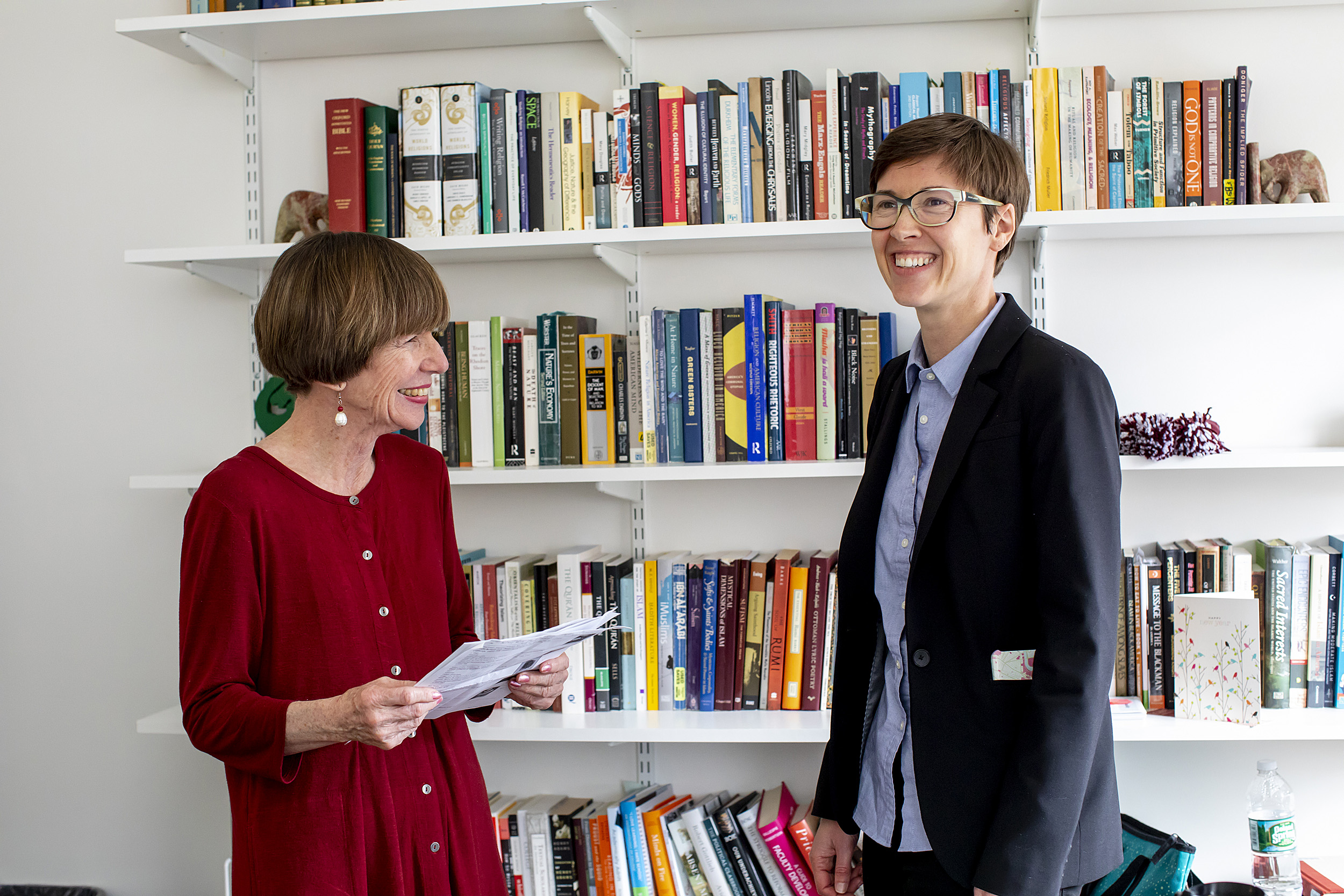 Kathleen Coleman (left) and Eleanor Finnegan chat in front of a bookcase