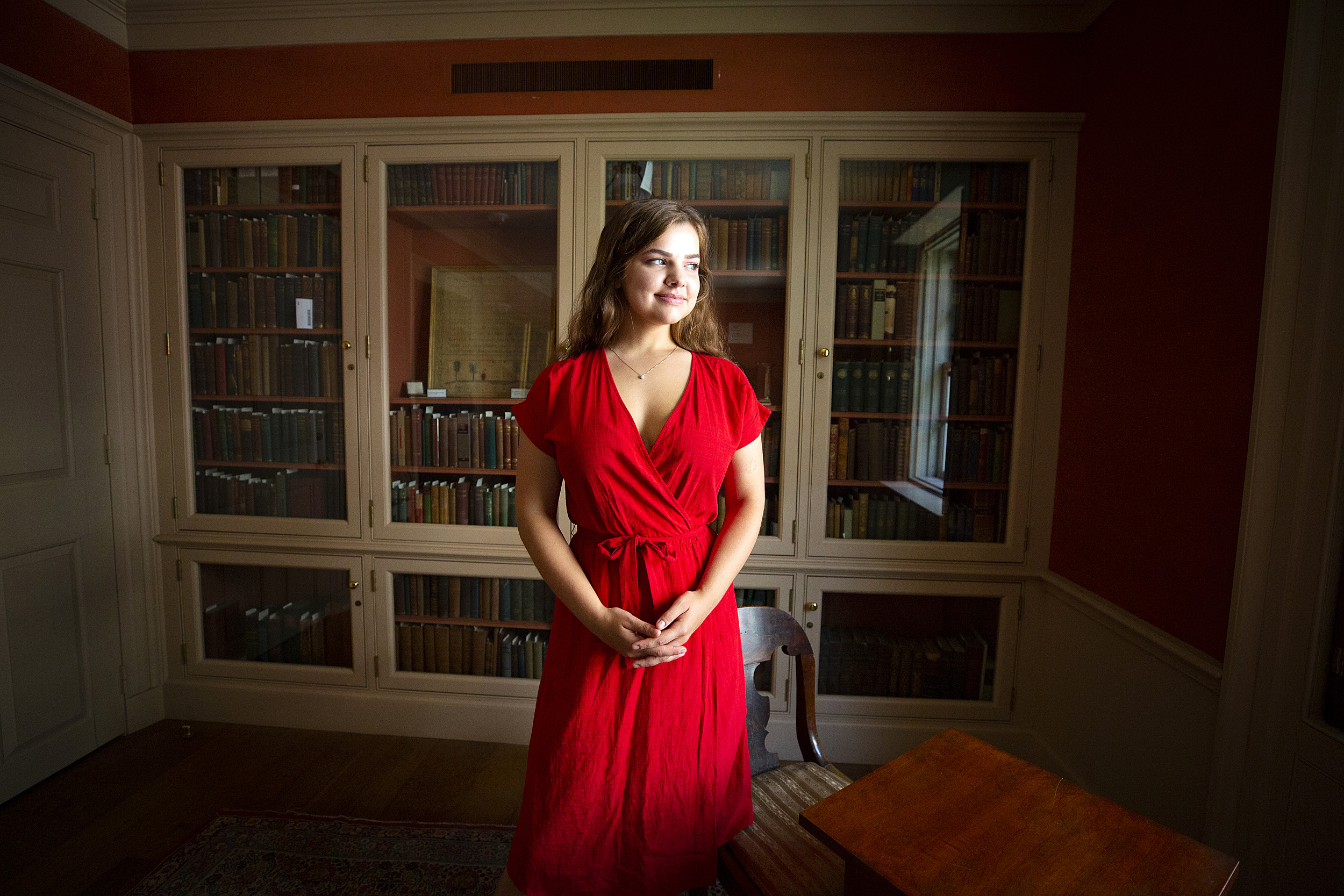 student in a red dress in the library
