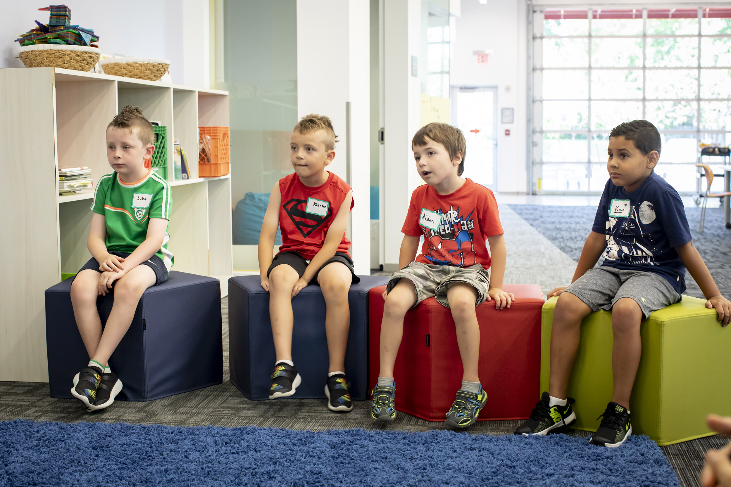 Luke Scanlon (from left), Kieran Bligh, Aiden Kiley, and Kaio Marques listen during poetry class.