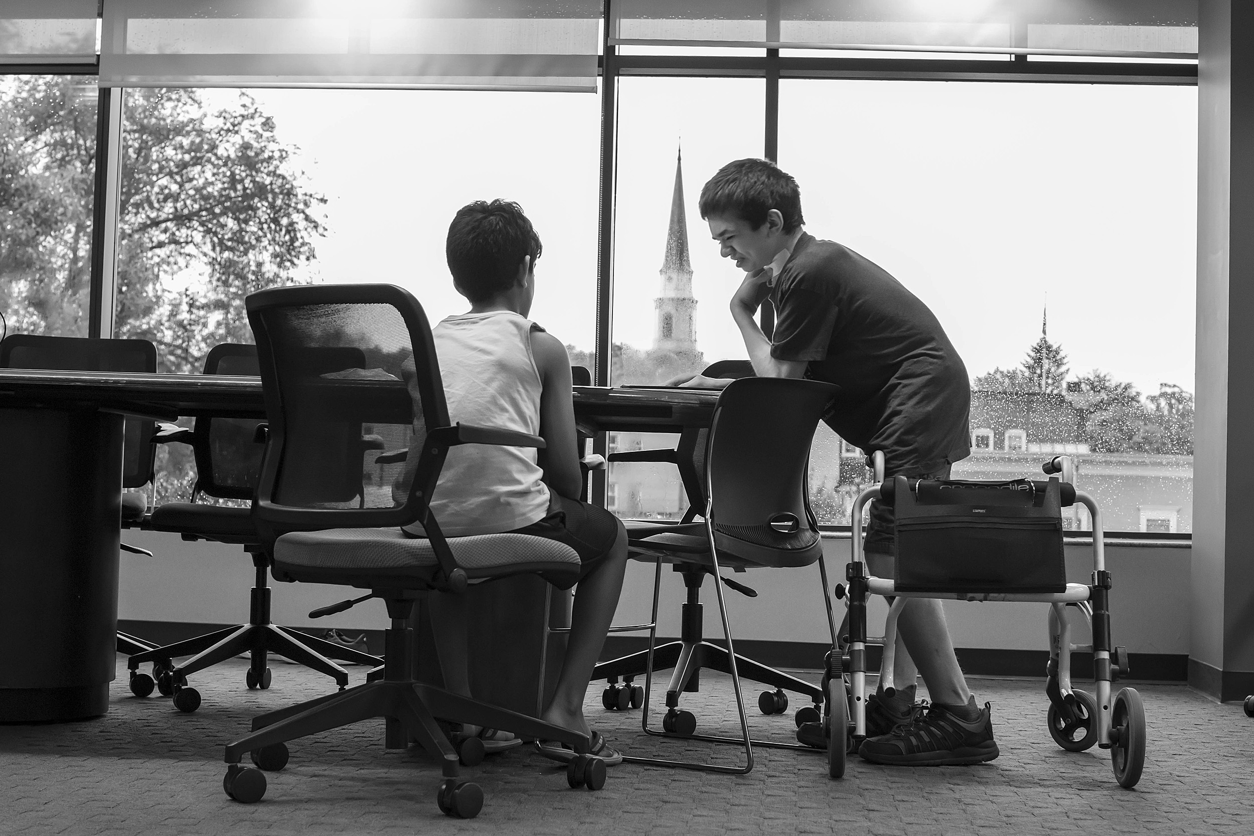 Ben Elwy works with an elementary school student in the library