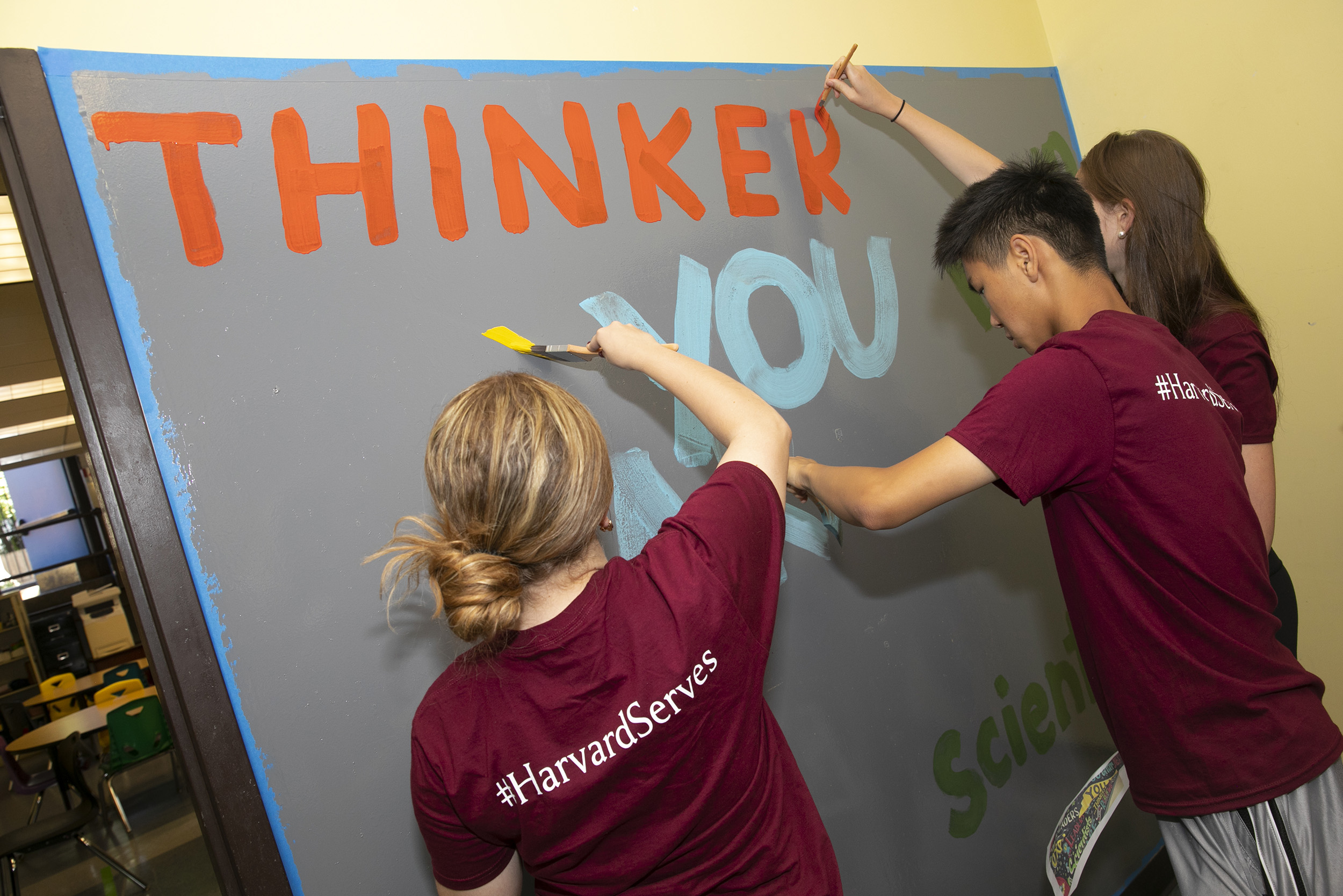 Students painting a wall