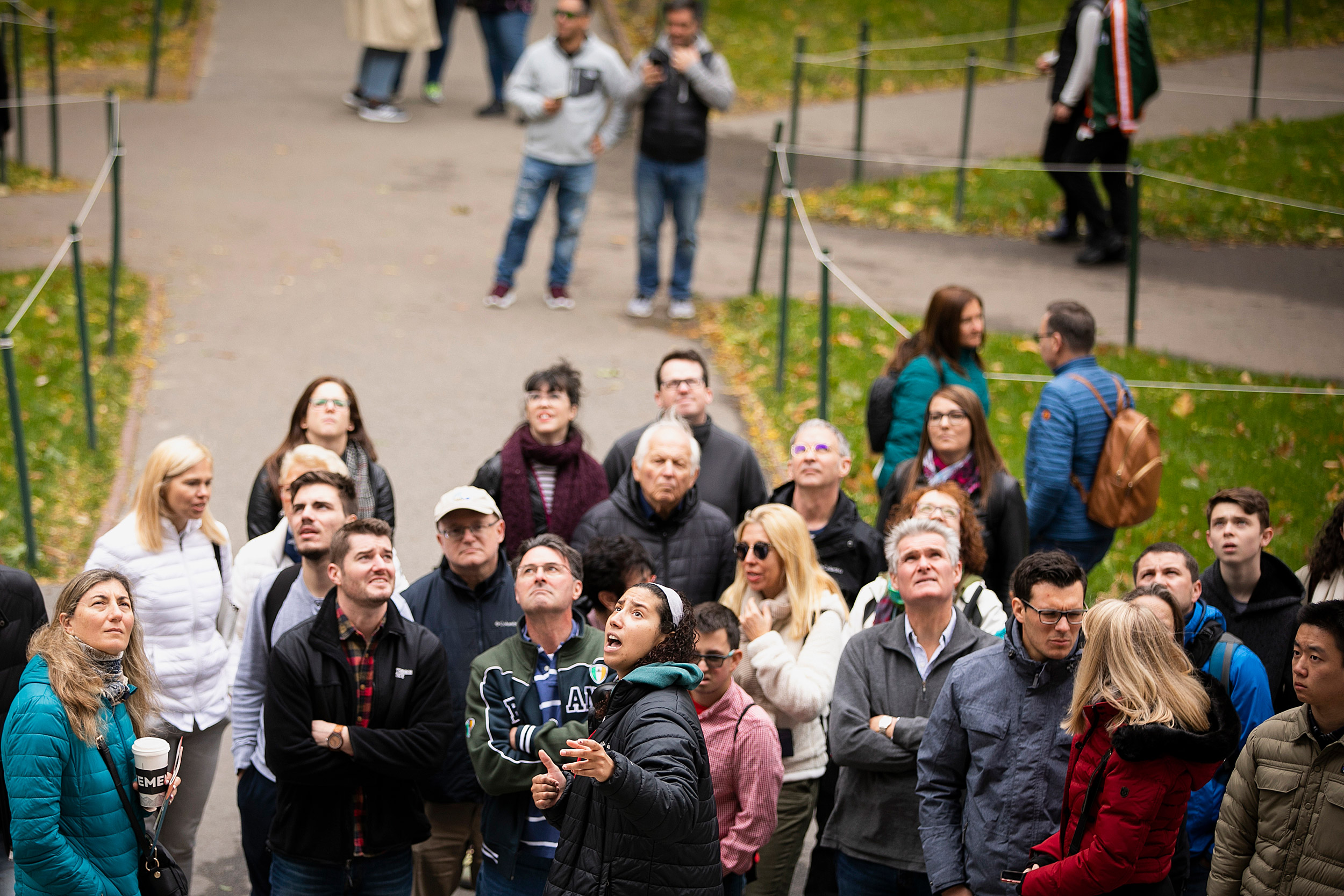 Tour group clusters outside Widener Library.