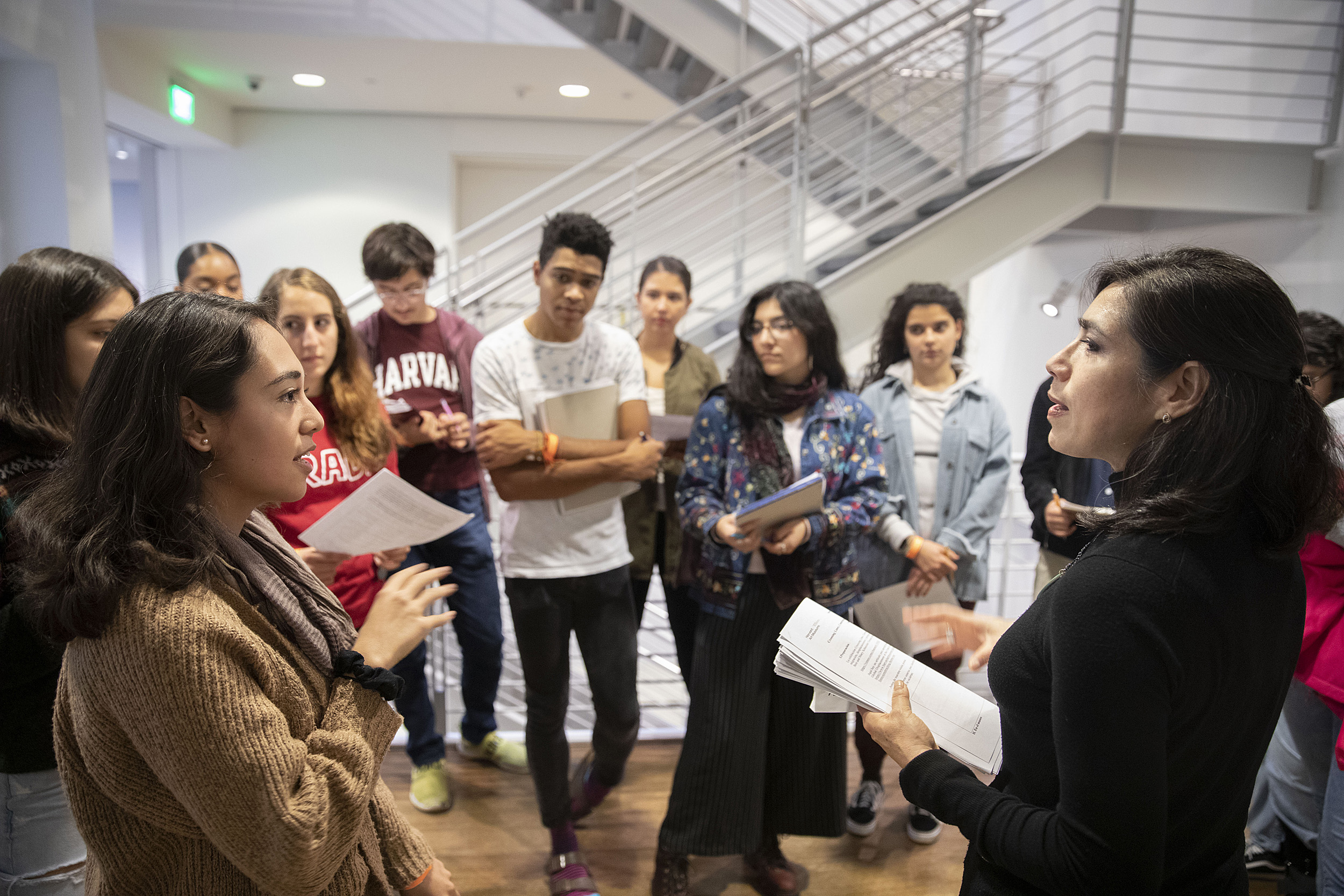 Professor discusses with a group of students.