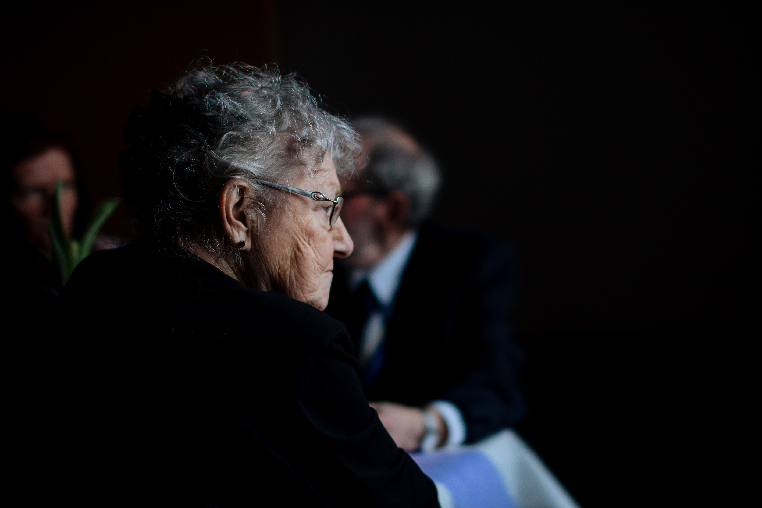 Elderly woman sitting.