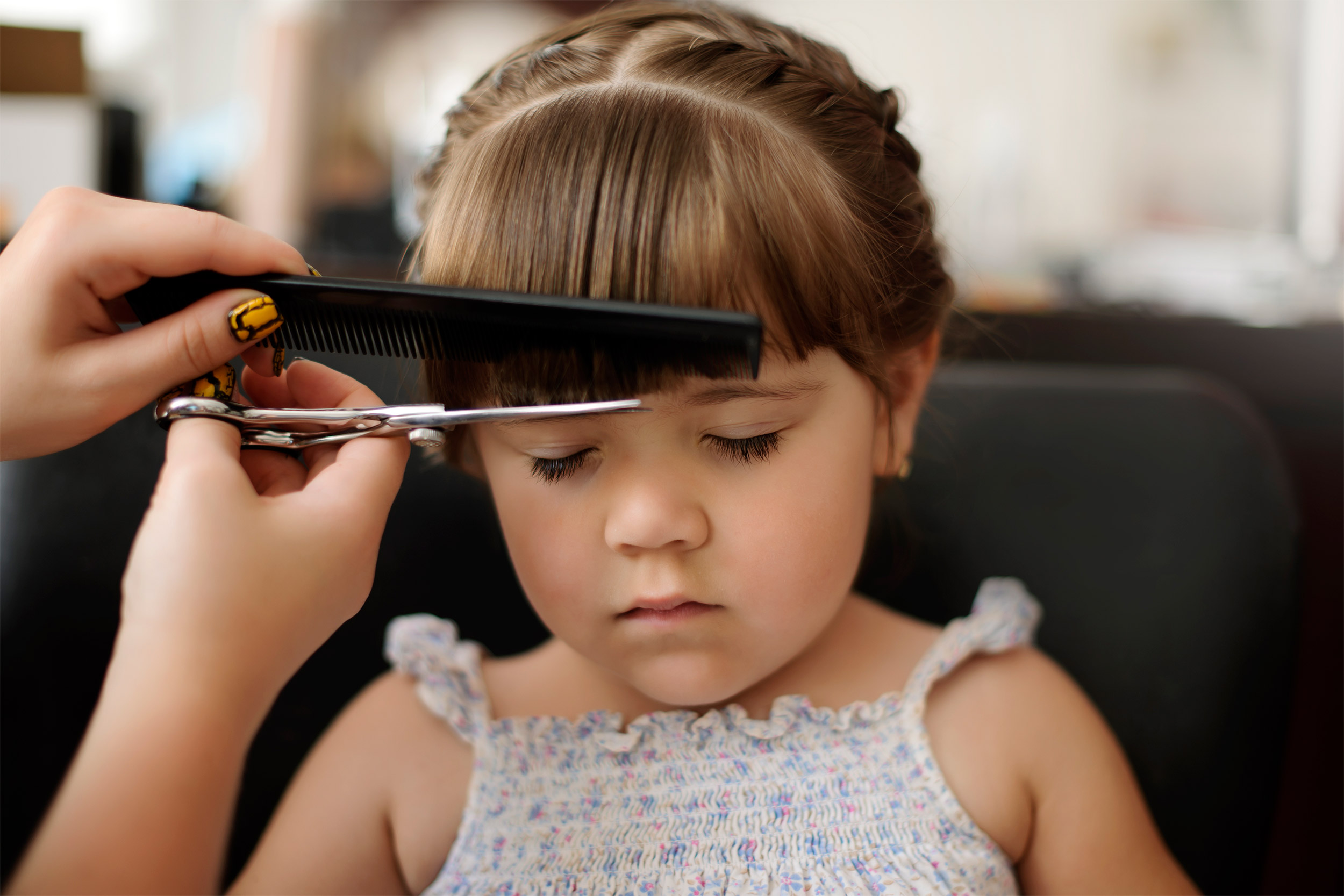 Little girl getting haircut.