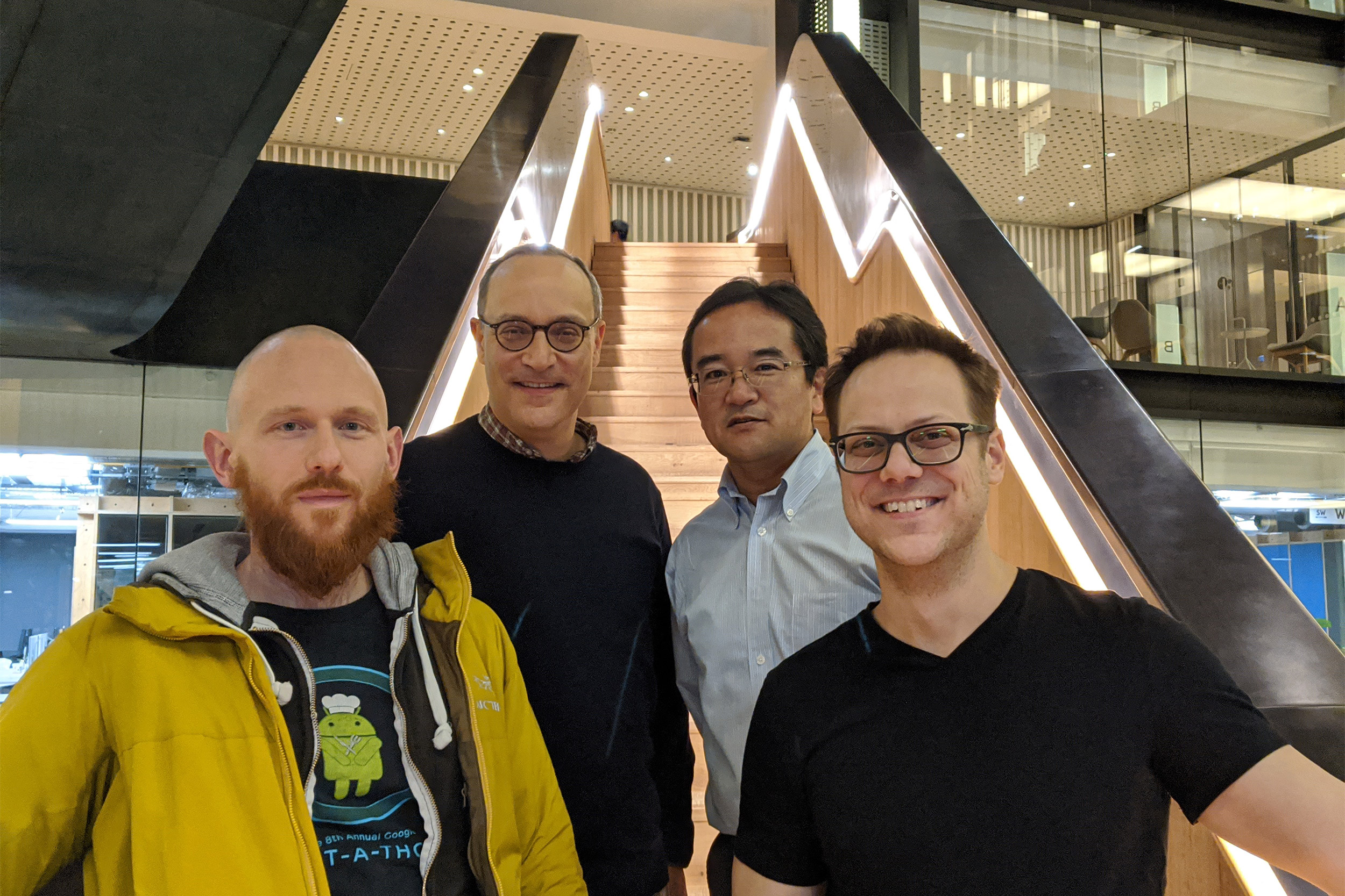 Researchers standing on stairwell.