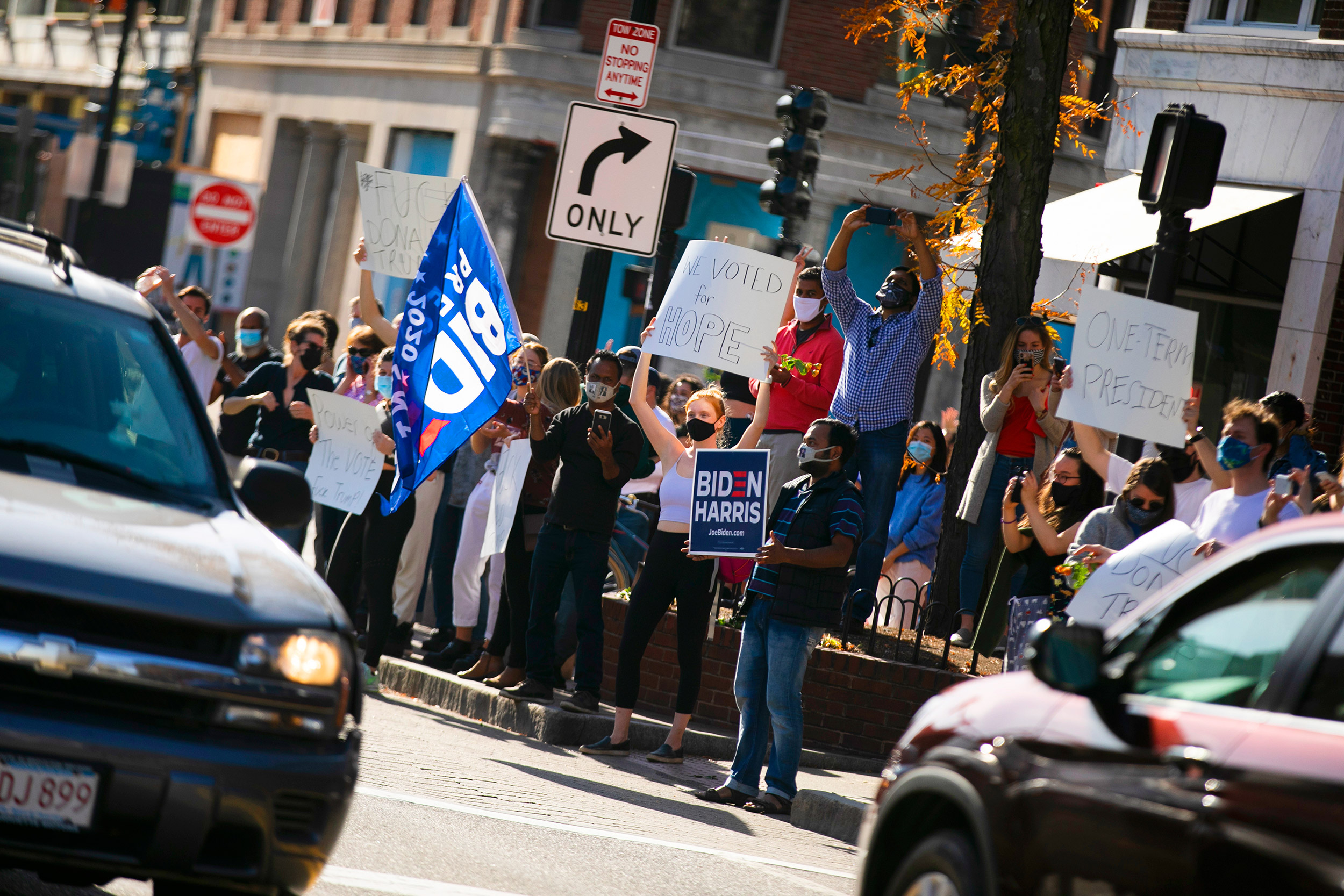 People on street corner with flags.