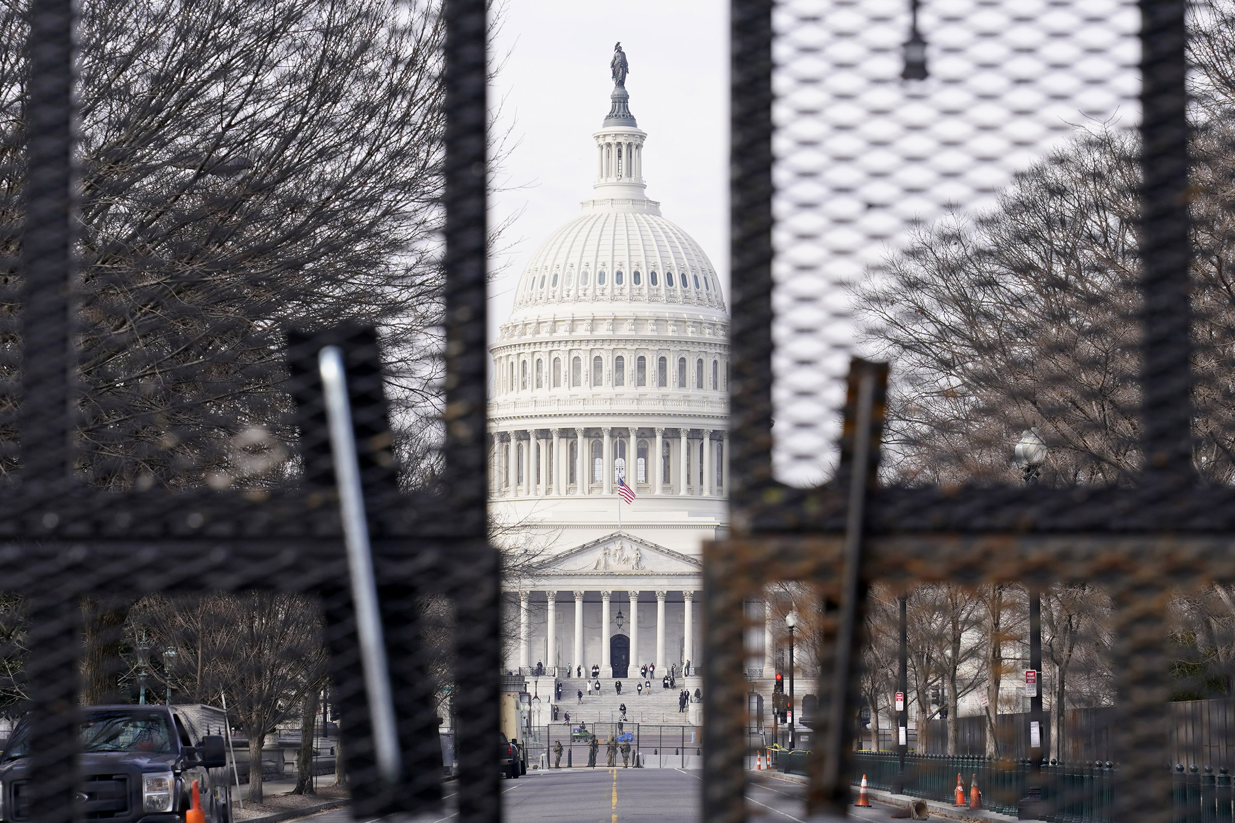 Capitol viewed through barricades.