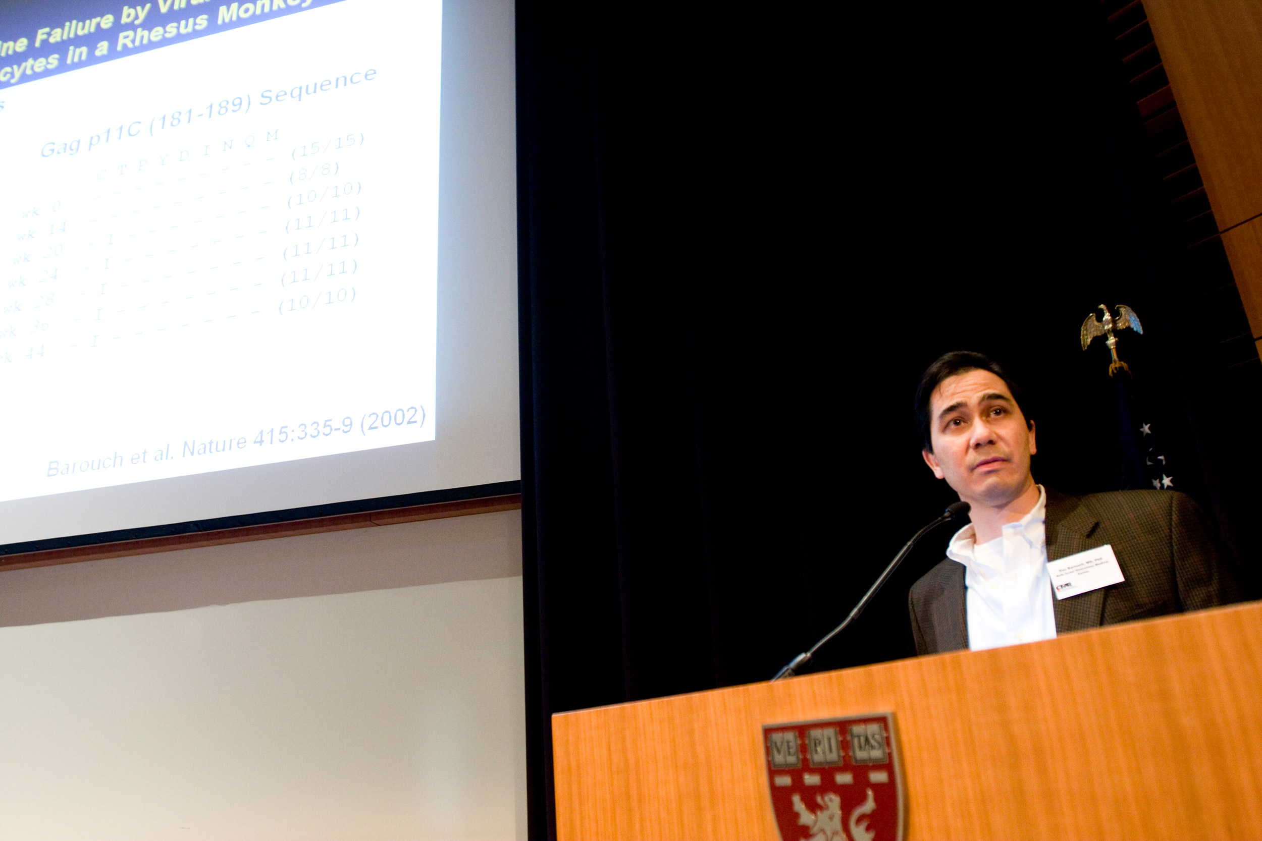 Dan Barouch standing at a podium.