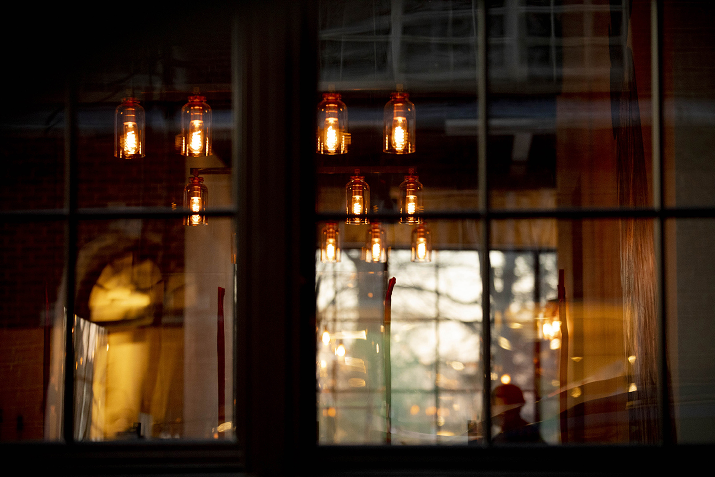 A patron watches tv inside Source a new restaurant on Church Street in Harvard Square.