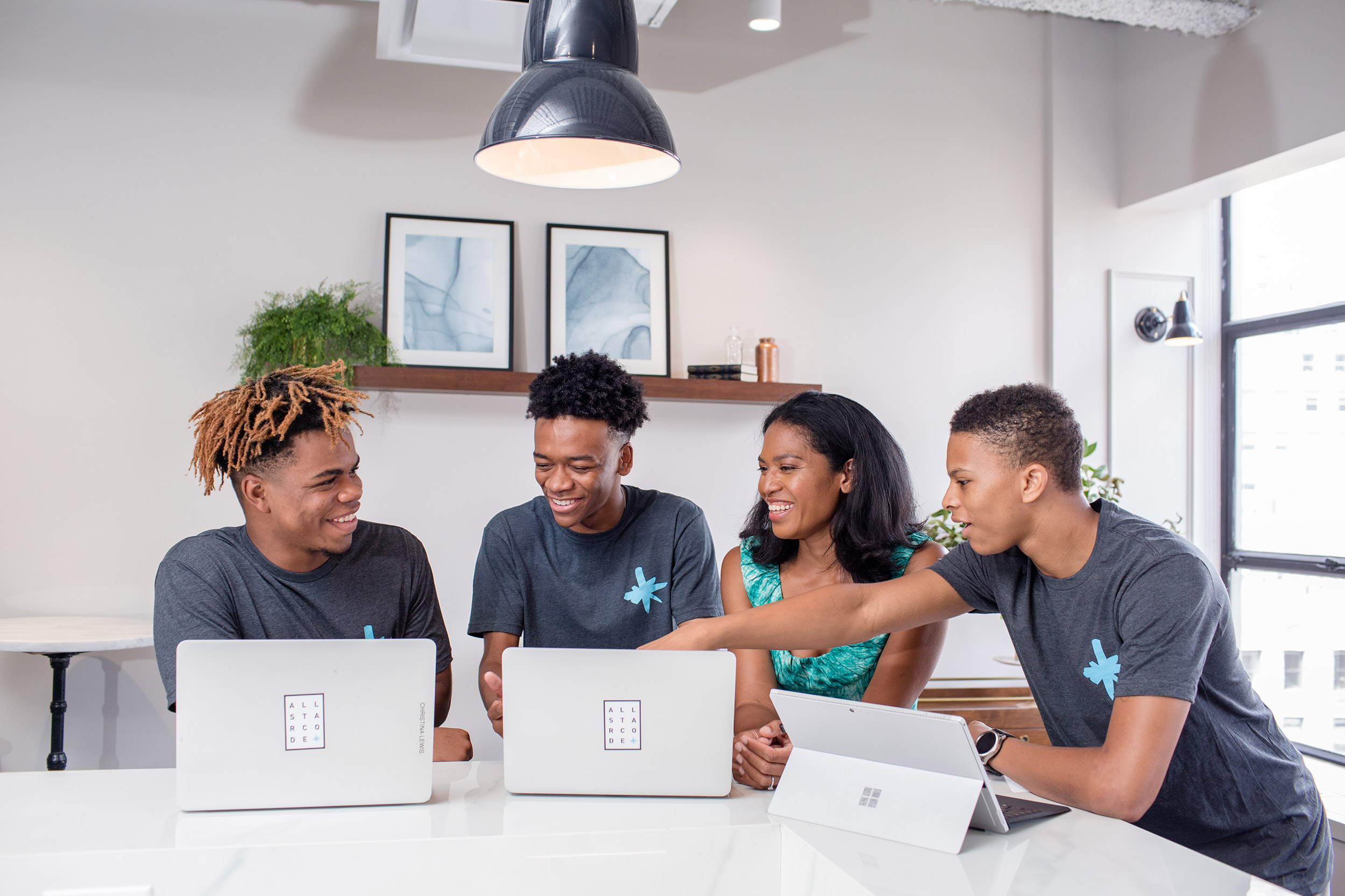 A group of students gathered around tablets.