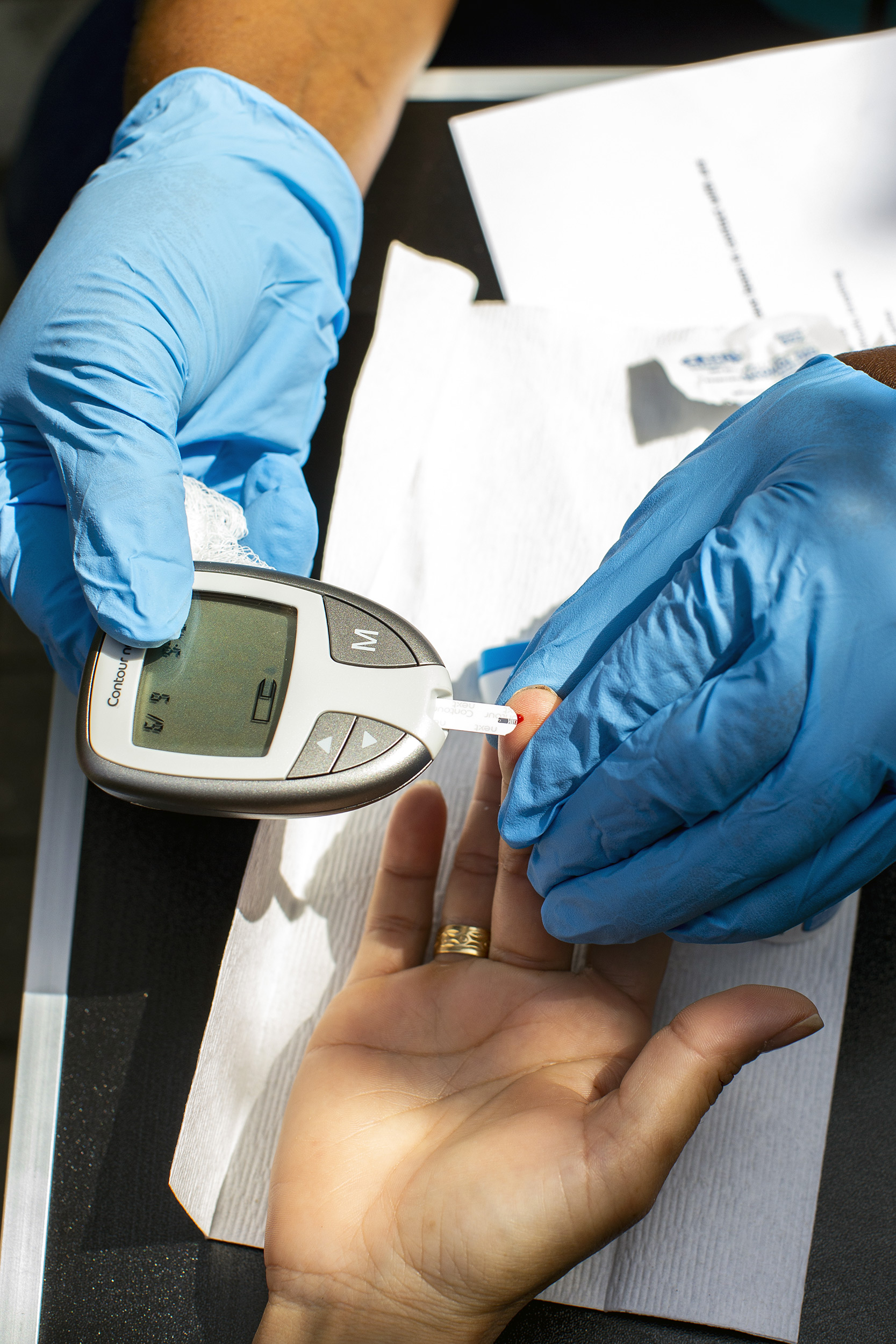 A member of the Family Van staff administers a blood sugar test.