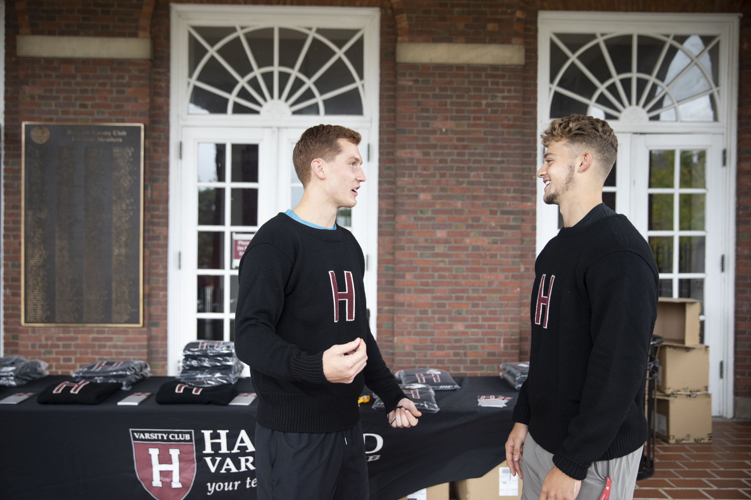 Two football players in varsity sweaters.