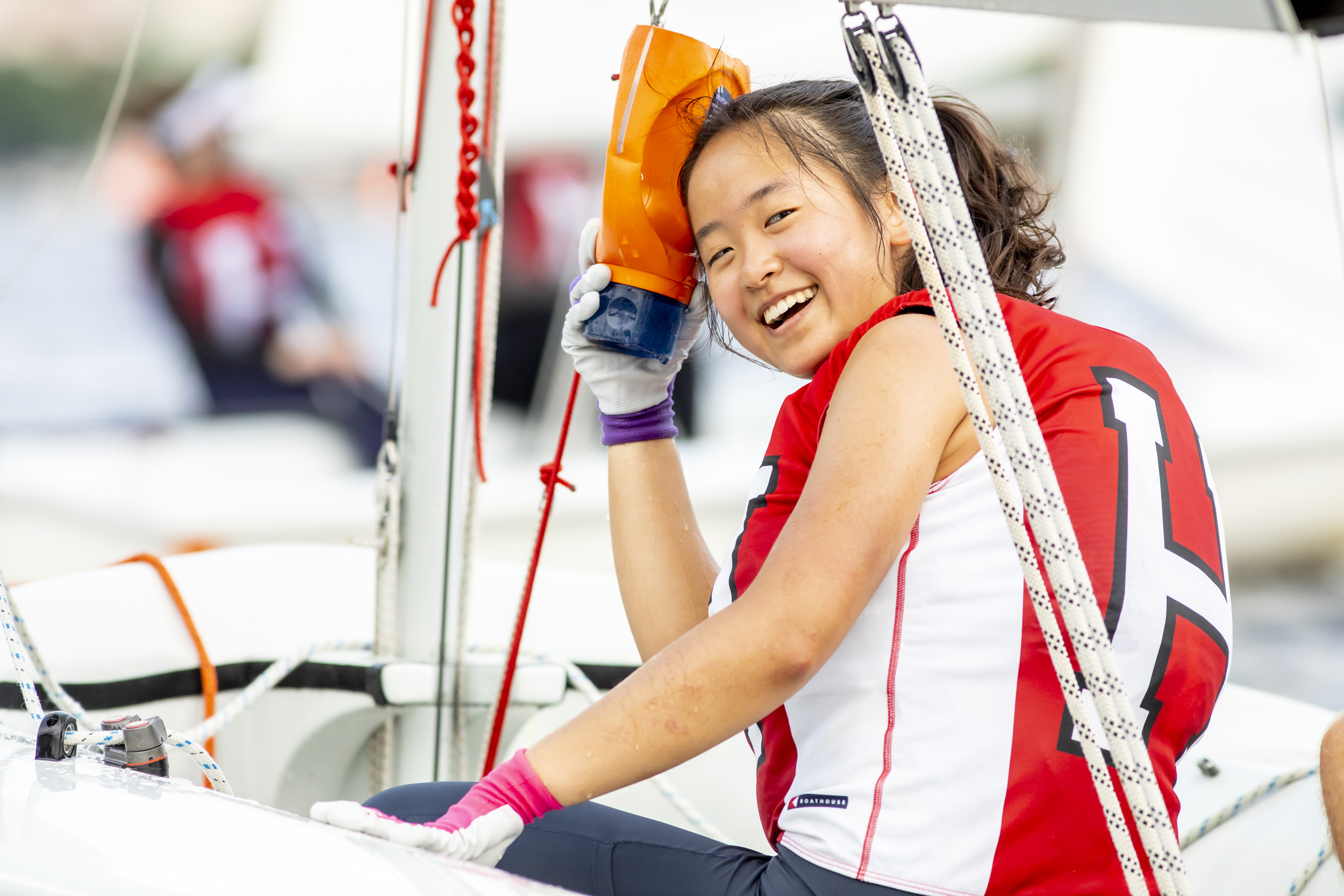 Carolyn Wang manages a smile after hitting her head on the boom. She ices the sore spot with the baler.