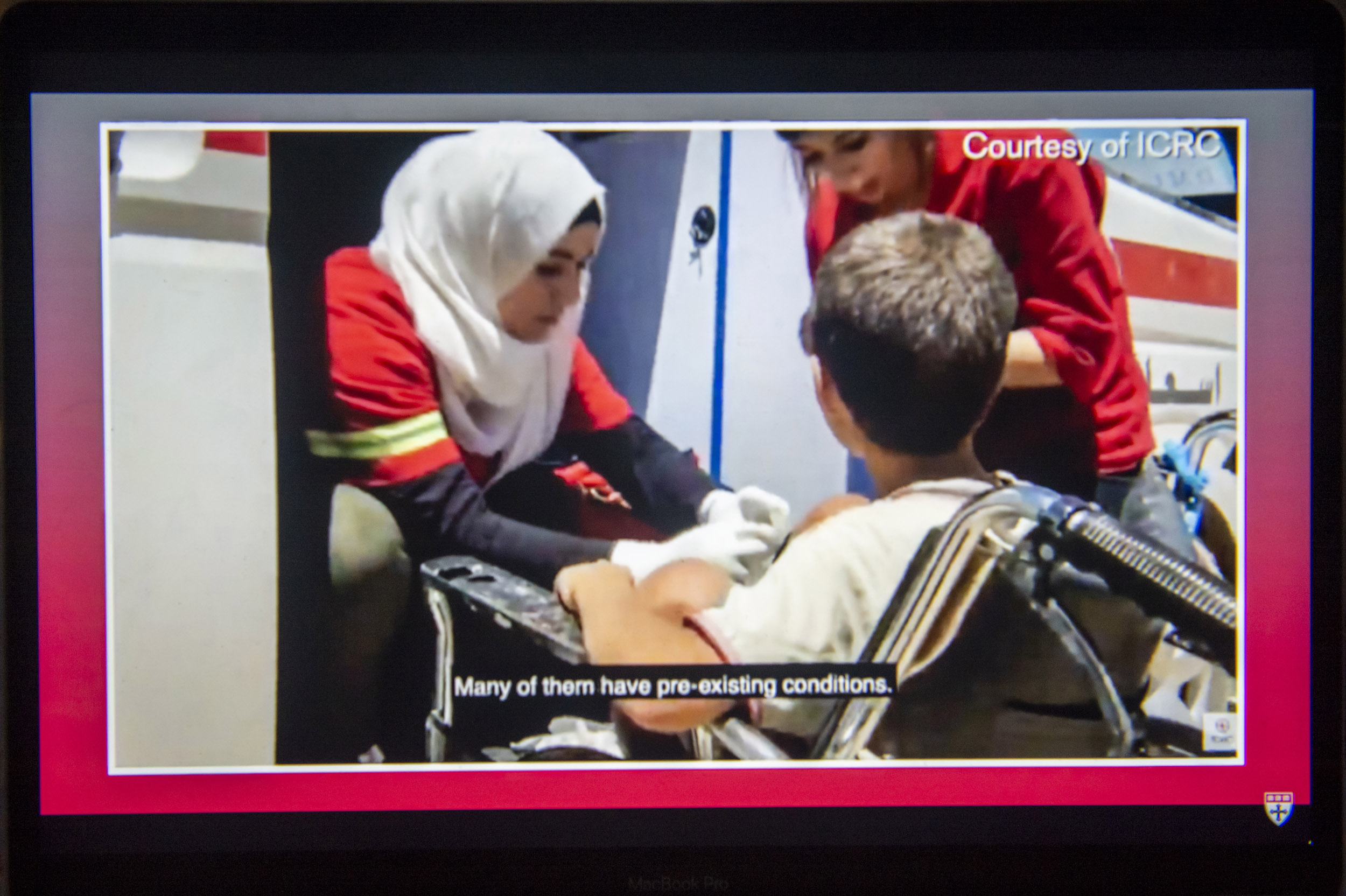 Red Cross worker helping boy.