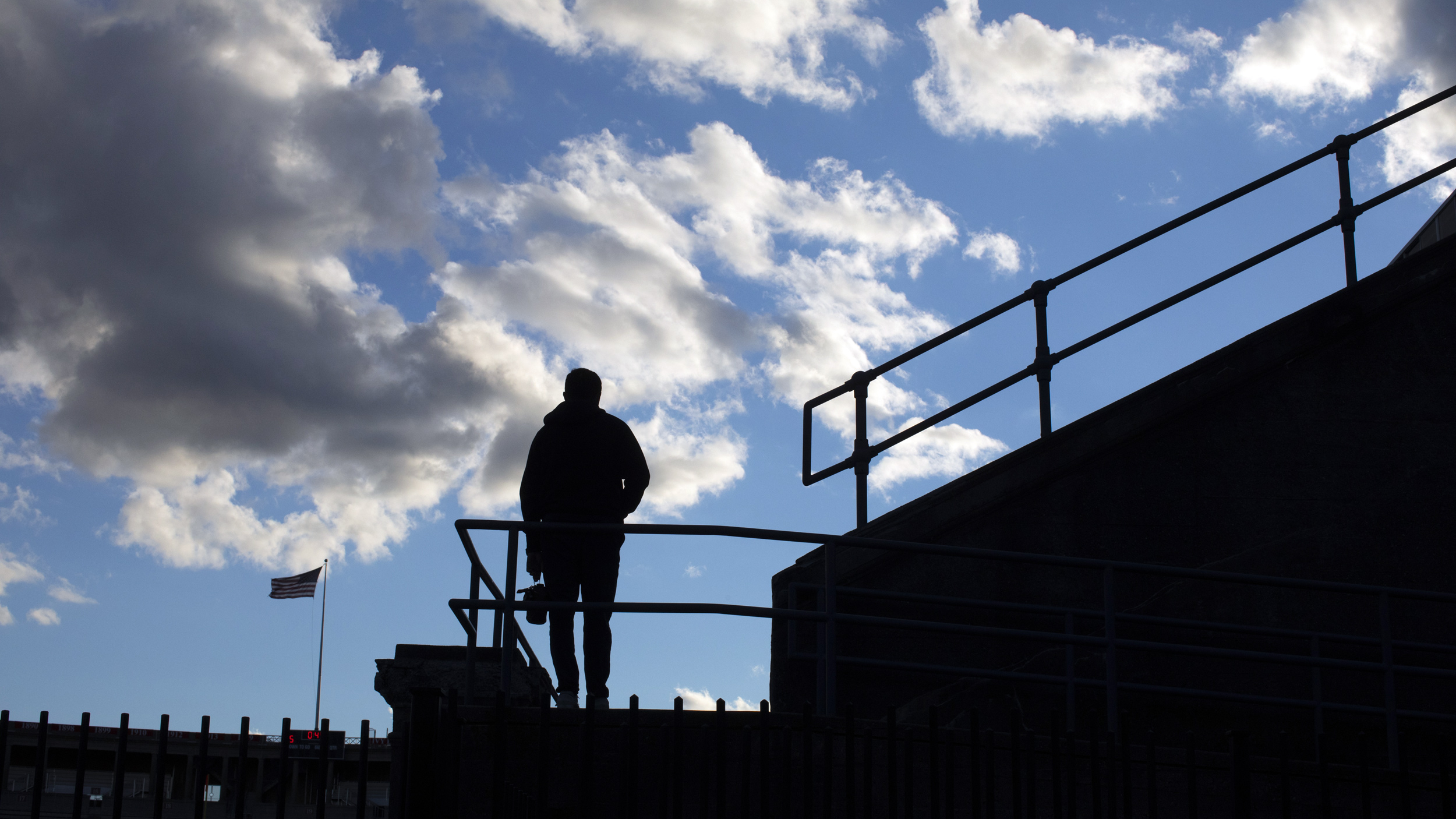 Silhouette of person at stadium.