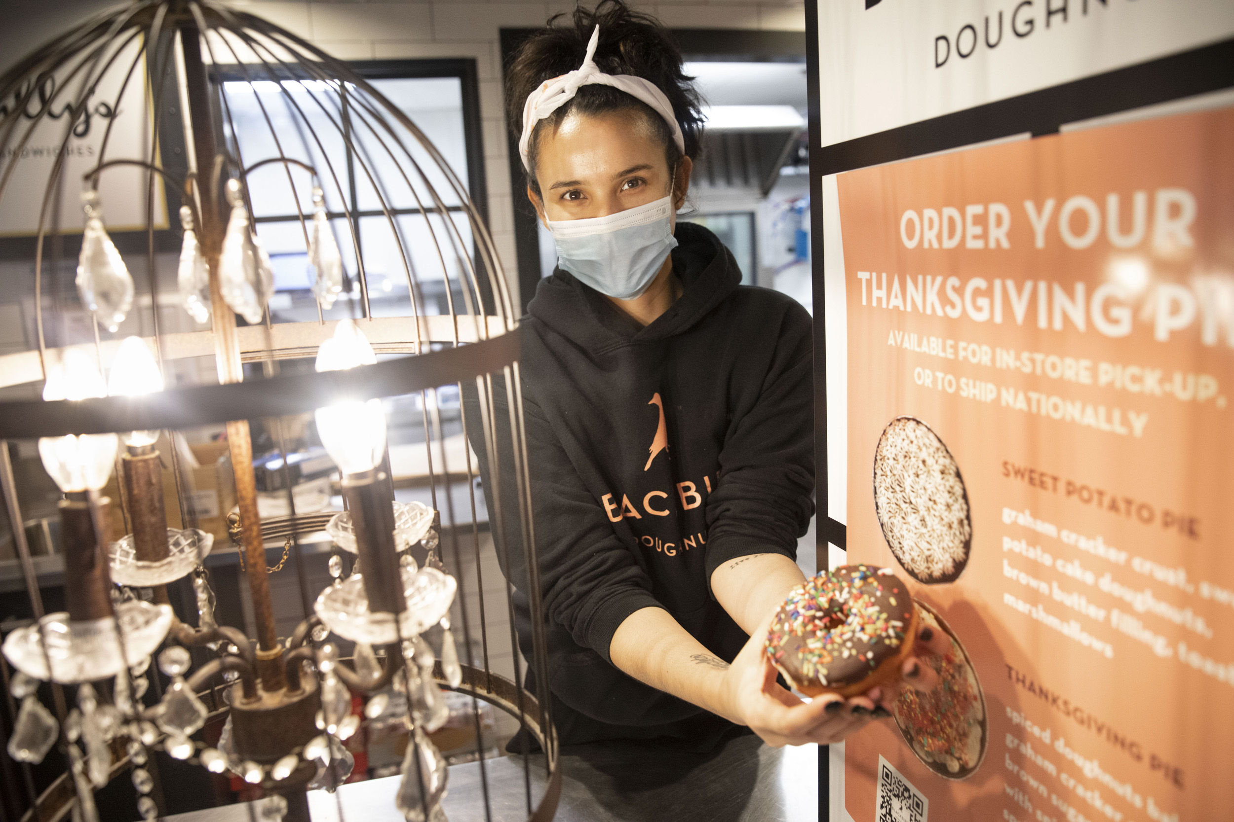 Leti Silva, manager of Sally's sandwiches and Blackbird Doughnuts, displays a gourmet doughnut.