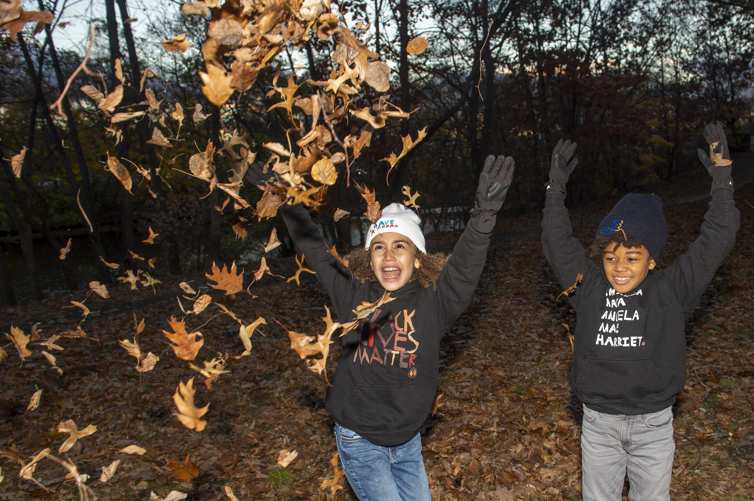 Children throwing leaves in air.