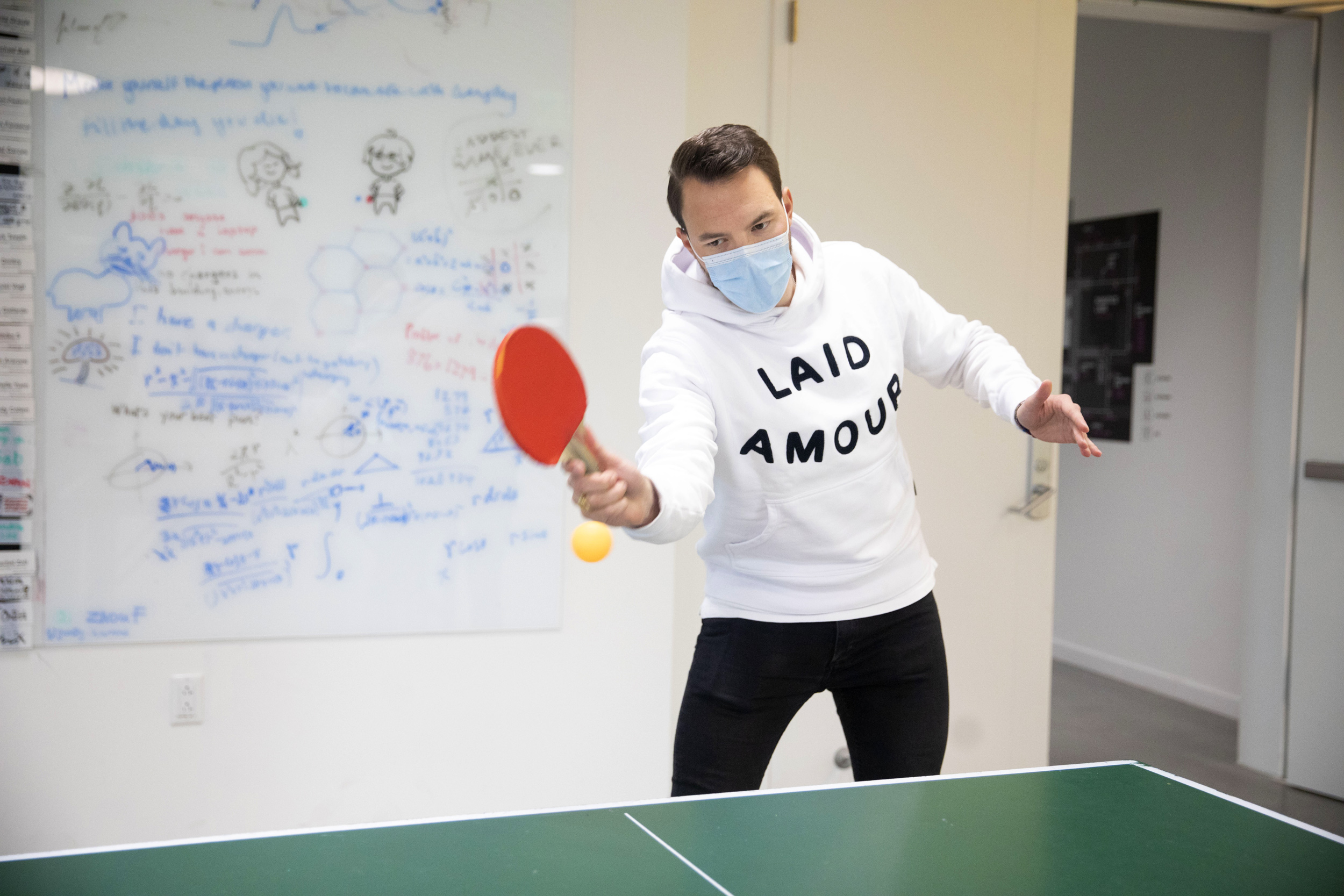 Alexander Roetheli, a fellow in materials science and mechanical engineering at SEAS, enjoys a heated Ping-Pong match with a lab member during a brief break inside the Science and Engineering Complex.