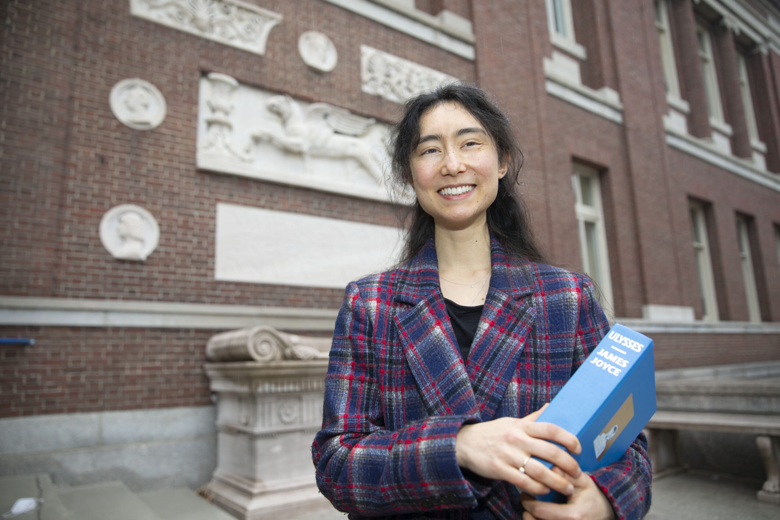 Sorcha Ashe holds copy of "Ulysses" outside Robinson Hall.