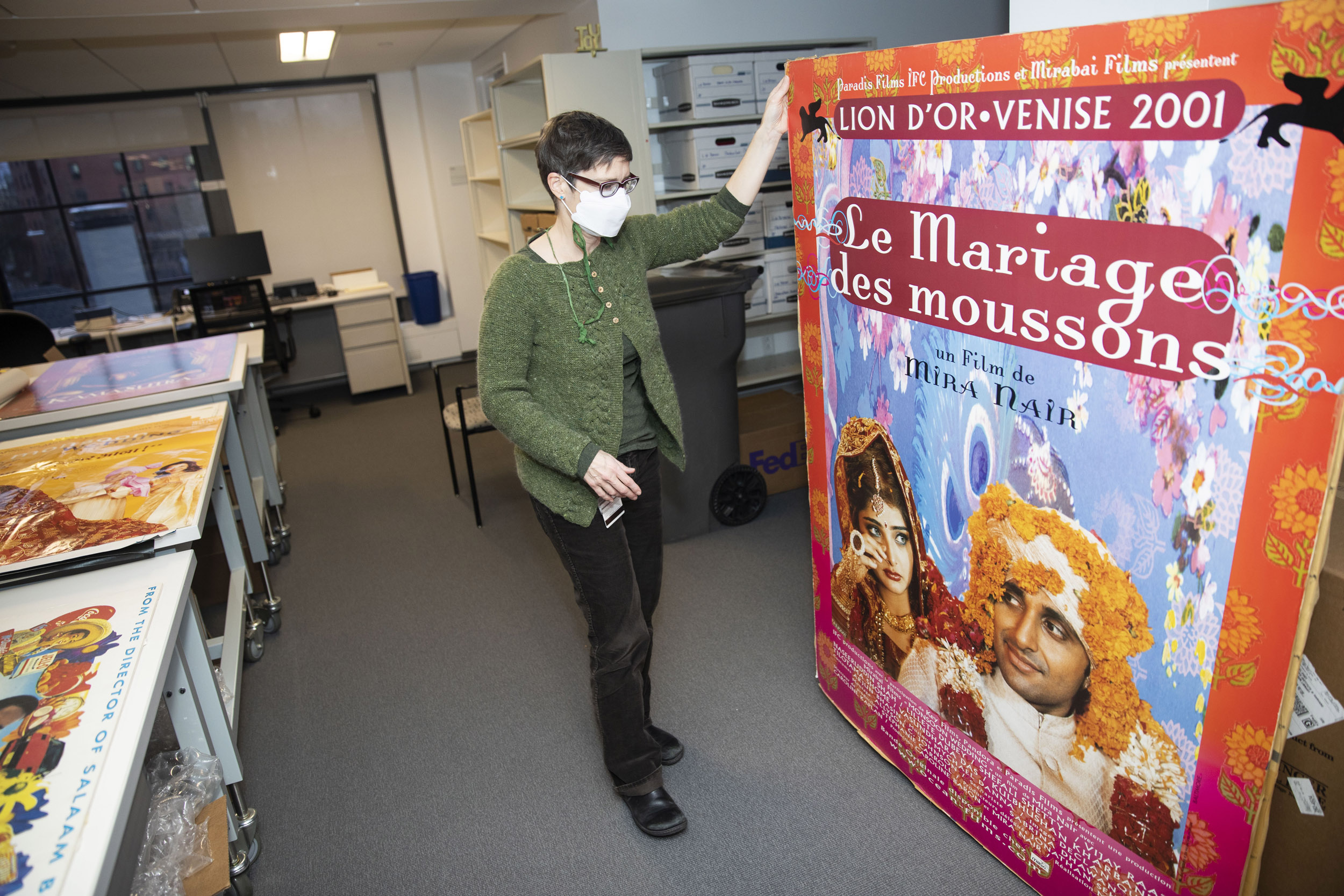 Jenny Gotwals displays poster from Mira Nair collection at Schlesinger Library.