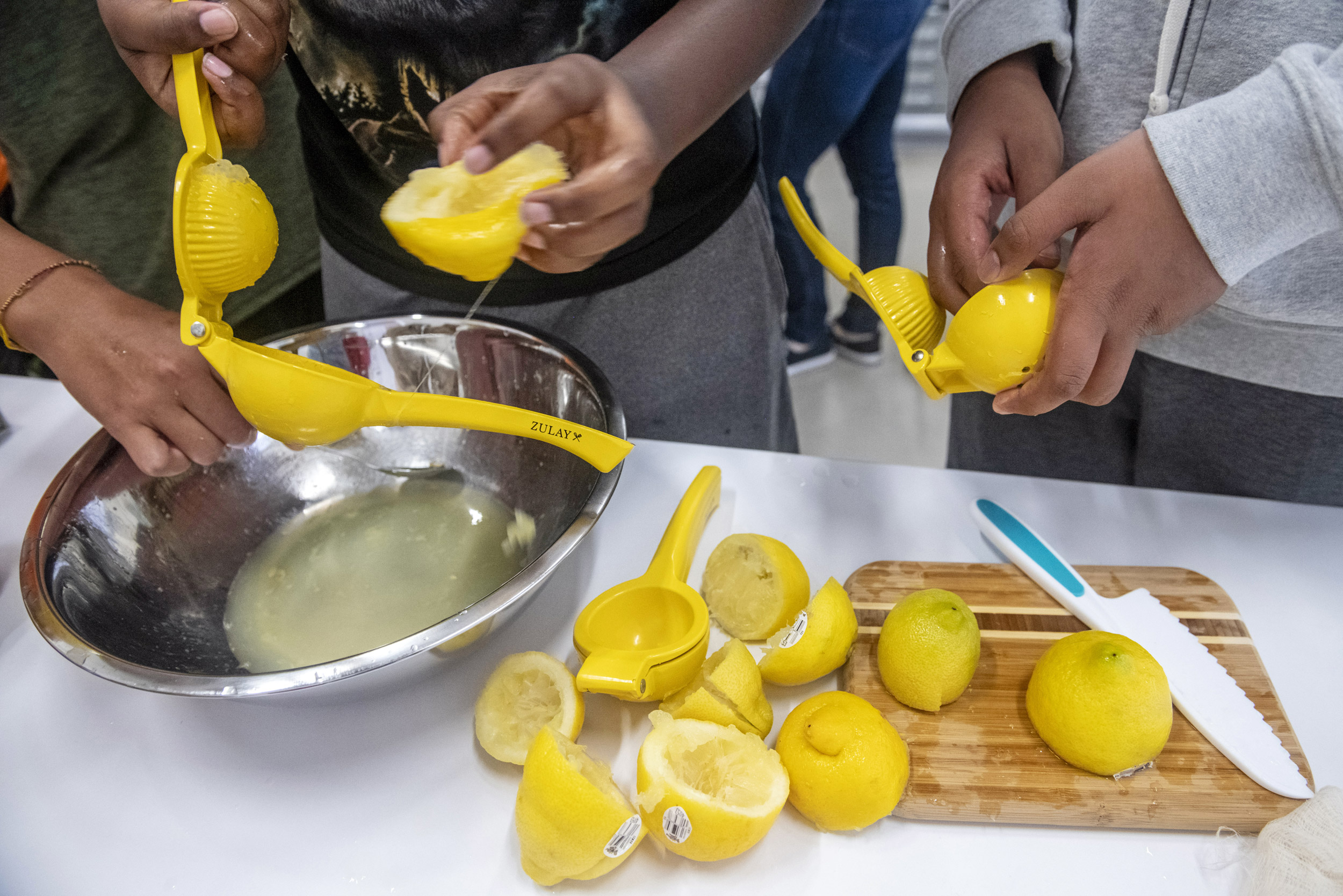 Lemons are squeezed to produce juice.