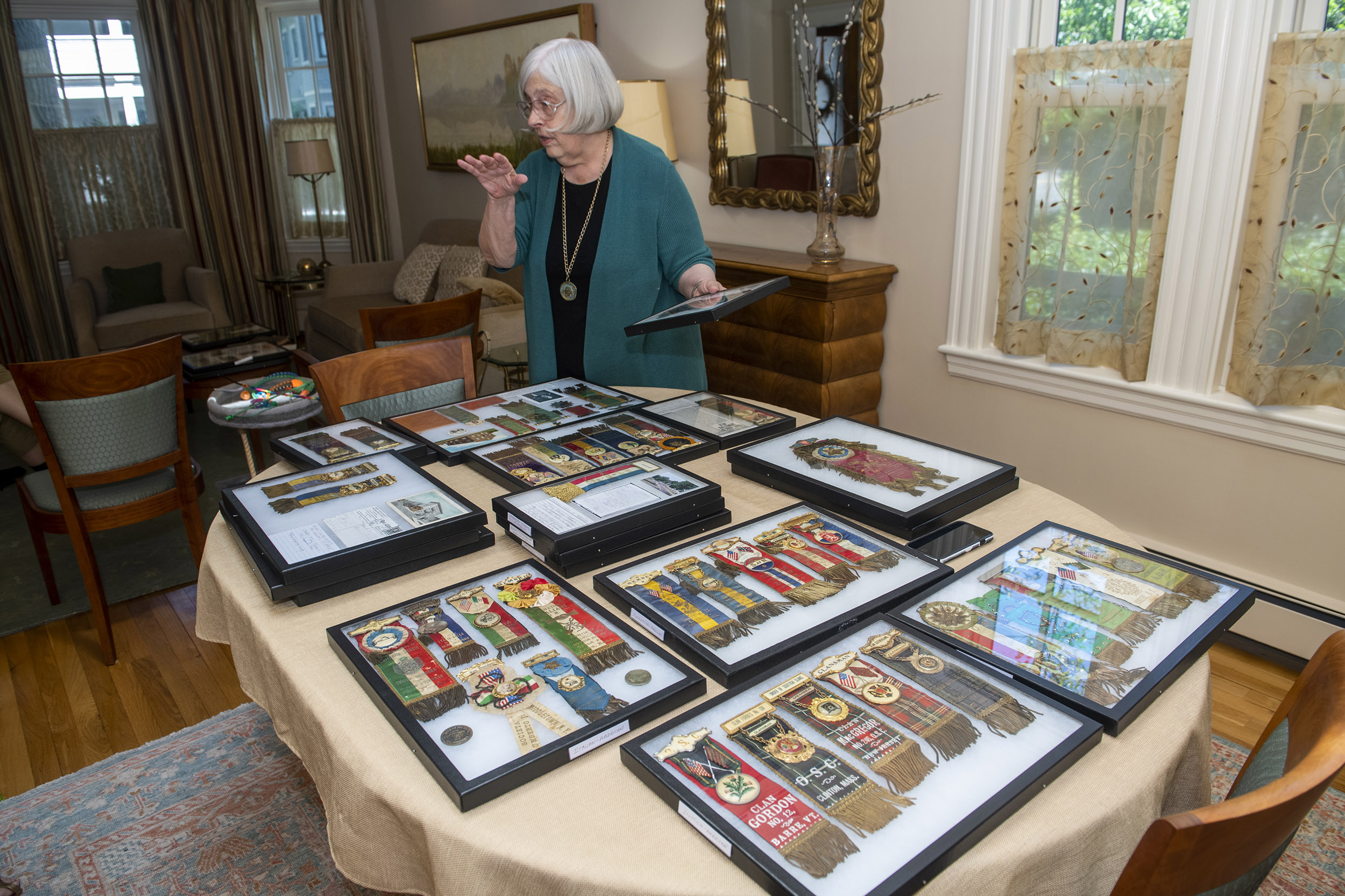 Theda Skocpol displays collection of badges.