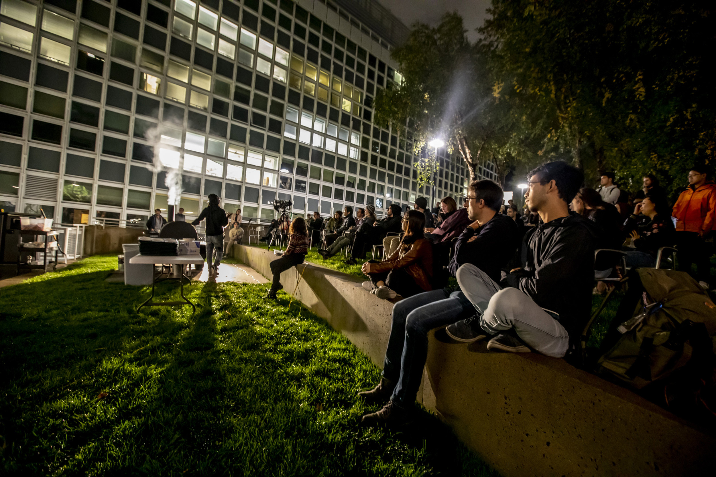 Students watching barbecue master.