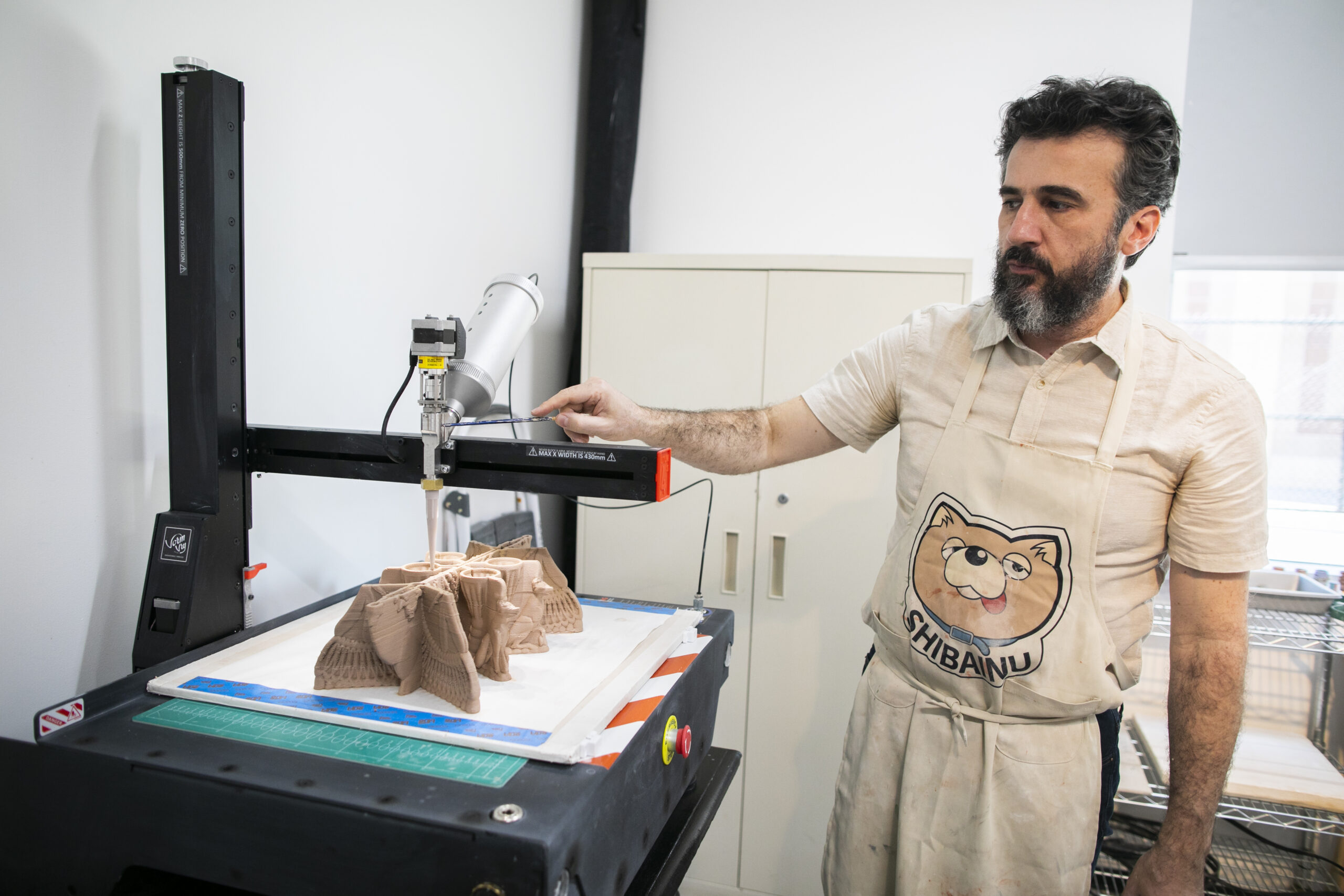 Artist Nicolas Touron builds a ceramic work using a 3D clay printer.