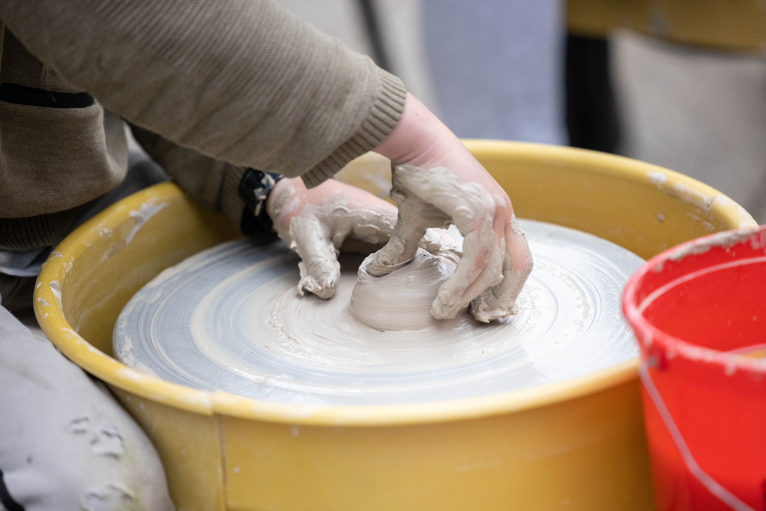 Children learn wheel throwing